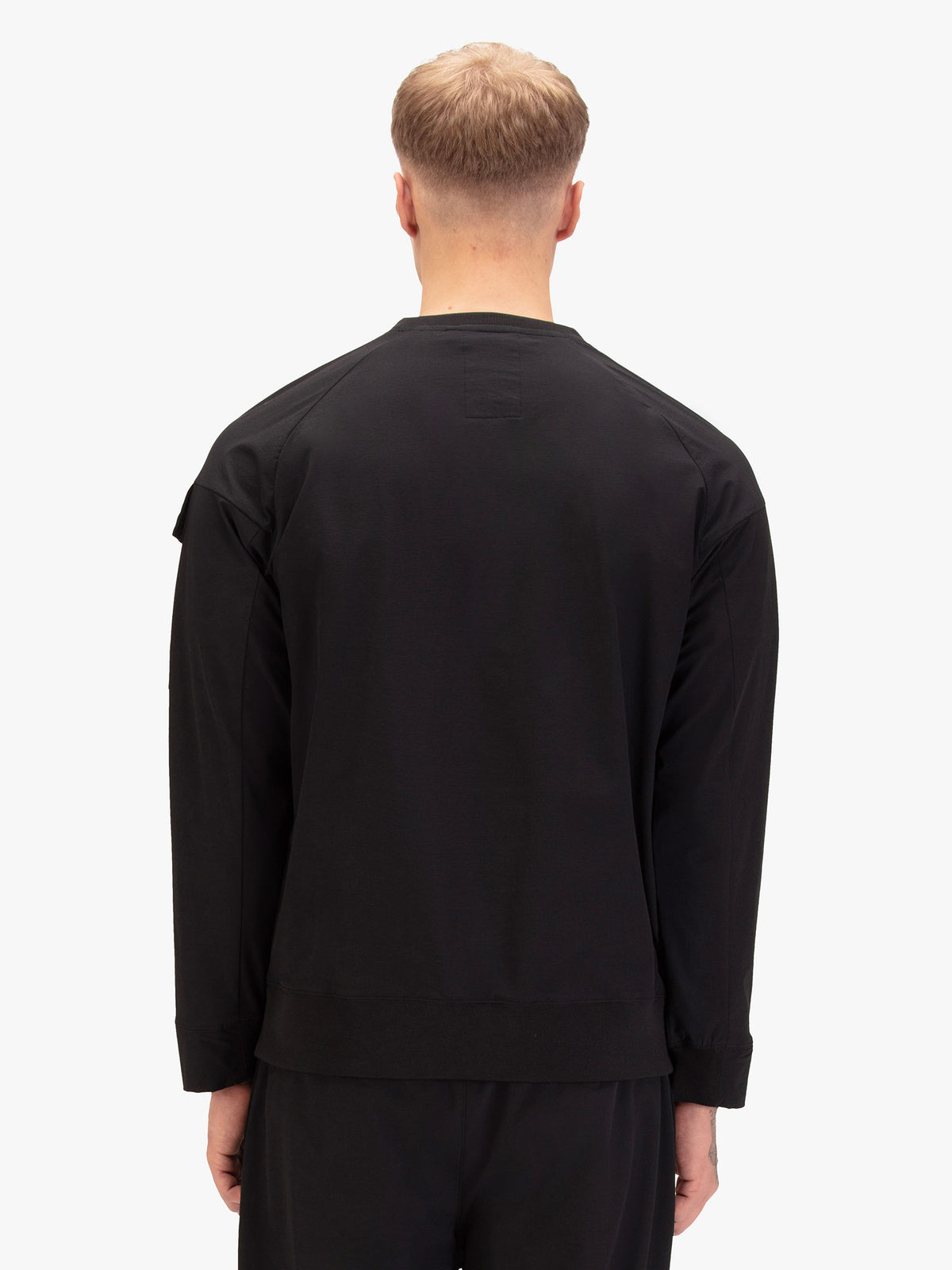 Men's black sweatshirt with crew neck, worn by a model, back view