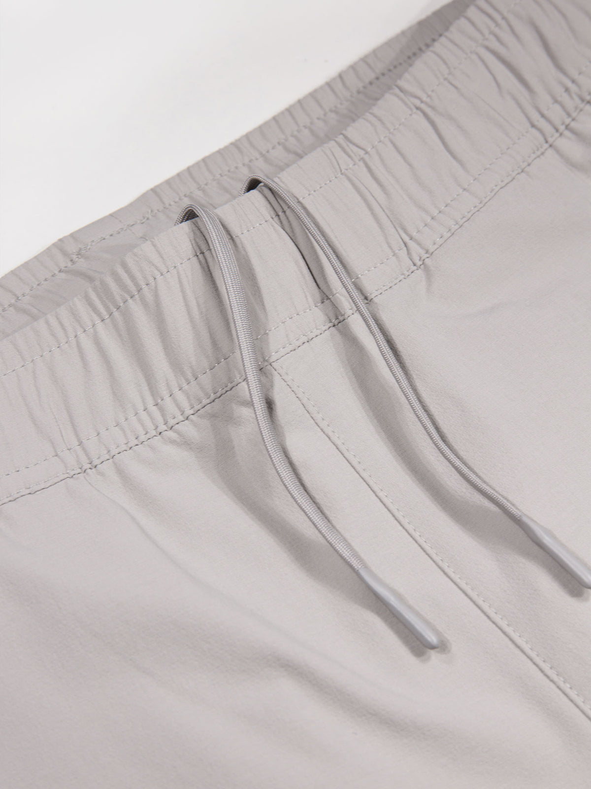 Men's grey joggers with elasticated waistband and cargo pockets.