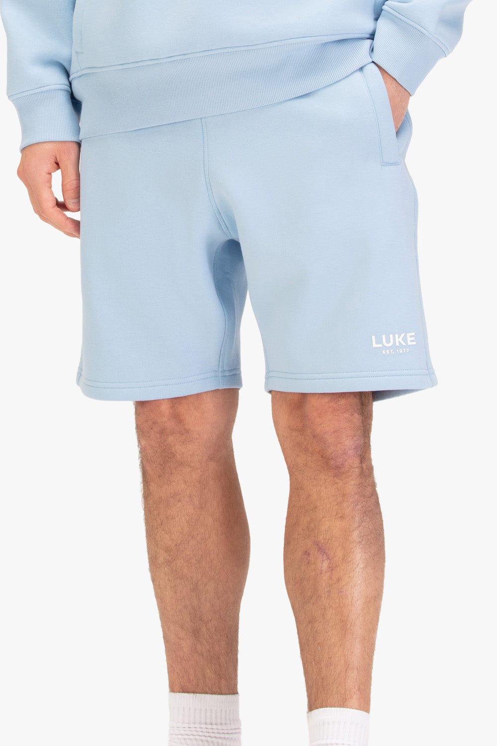 Men's blue shorts with drawstring waistband, worn by a model, front view2