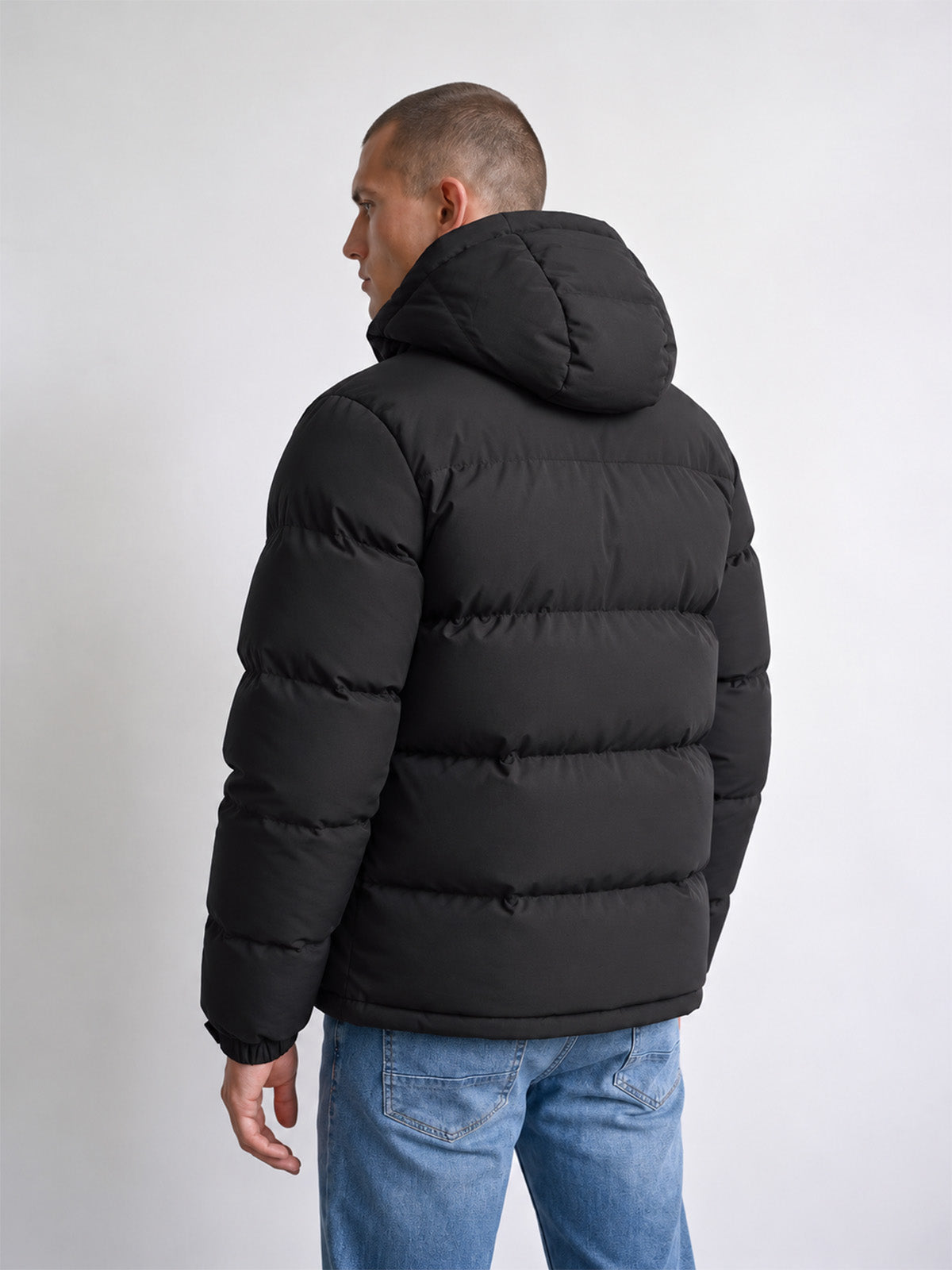Back view of black LUKE 1977 Auckland hooded padded jacket worn by model
