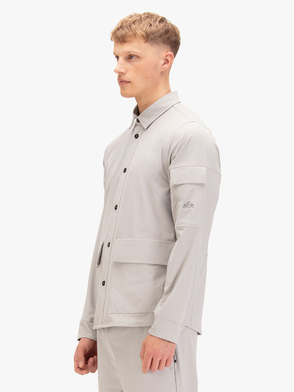 Side view of man wearing cement grey LUKE 1977 Canavese technical shirt with sleeve pocket