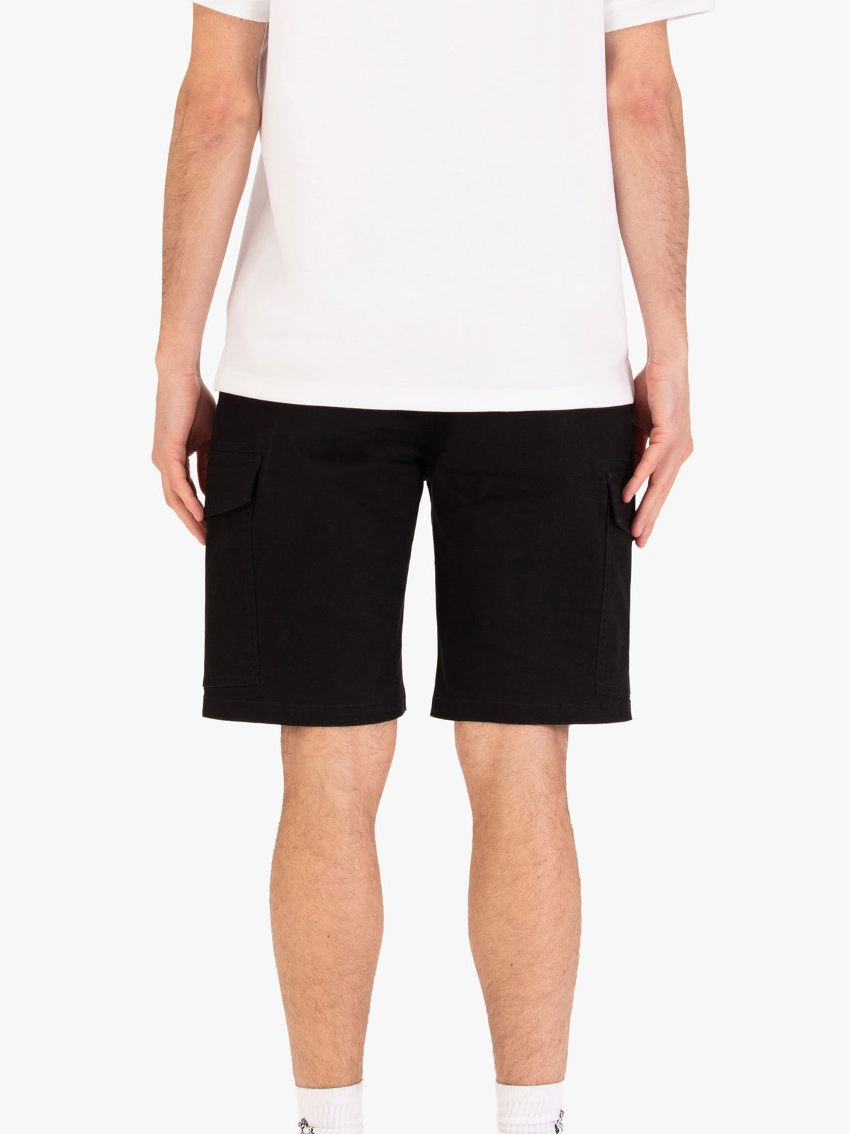 Men's black shorts with drawstring waistband and cargo pockets, worn by a model, back view