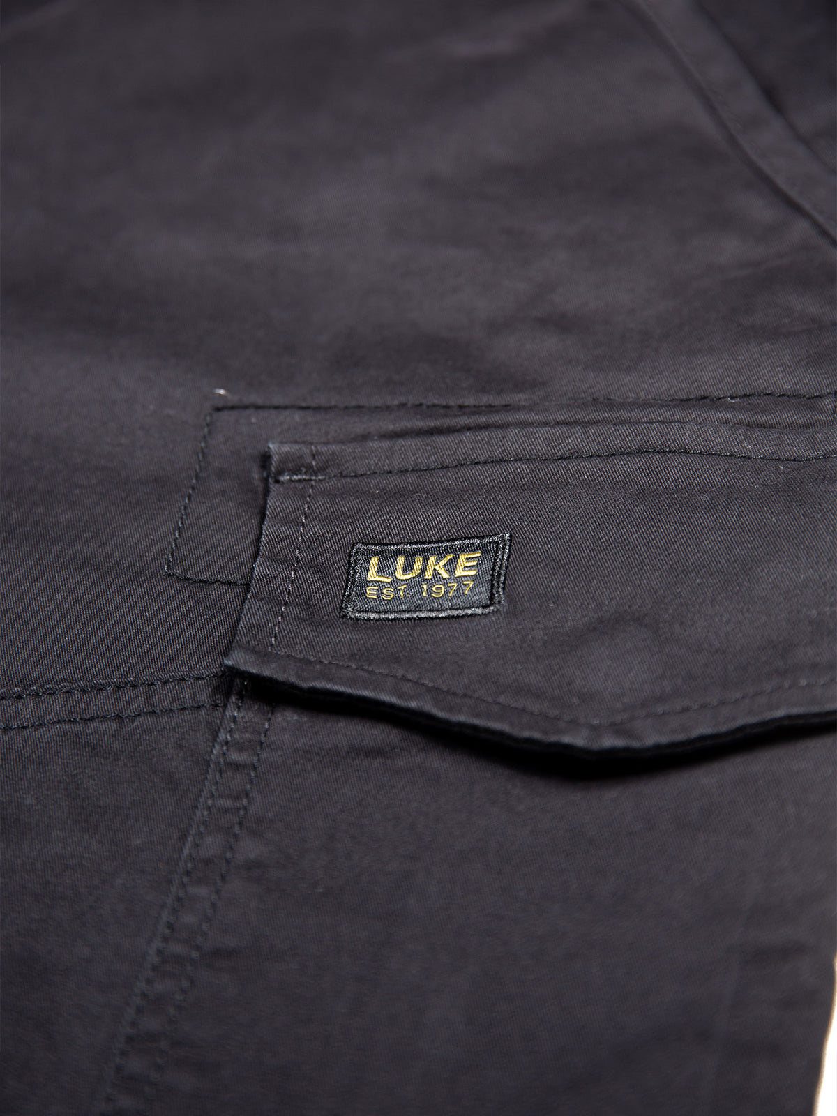Men's black shorts with drawstring waistband and cargo pockets, detail view 2