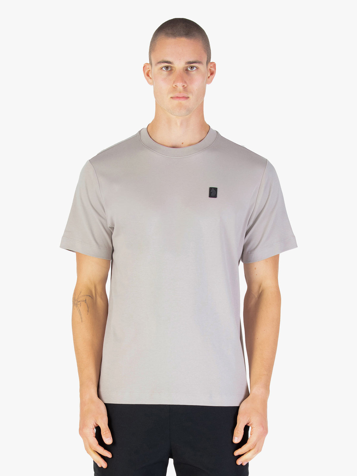 Men's relaxed-fit grey t-shirt with crew neck and short sleeves worn by a model - side view.