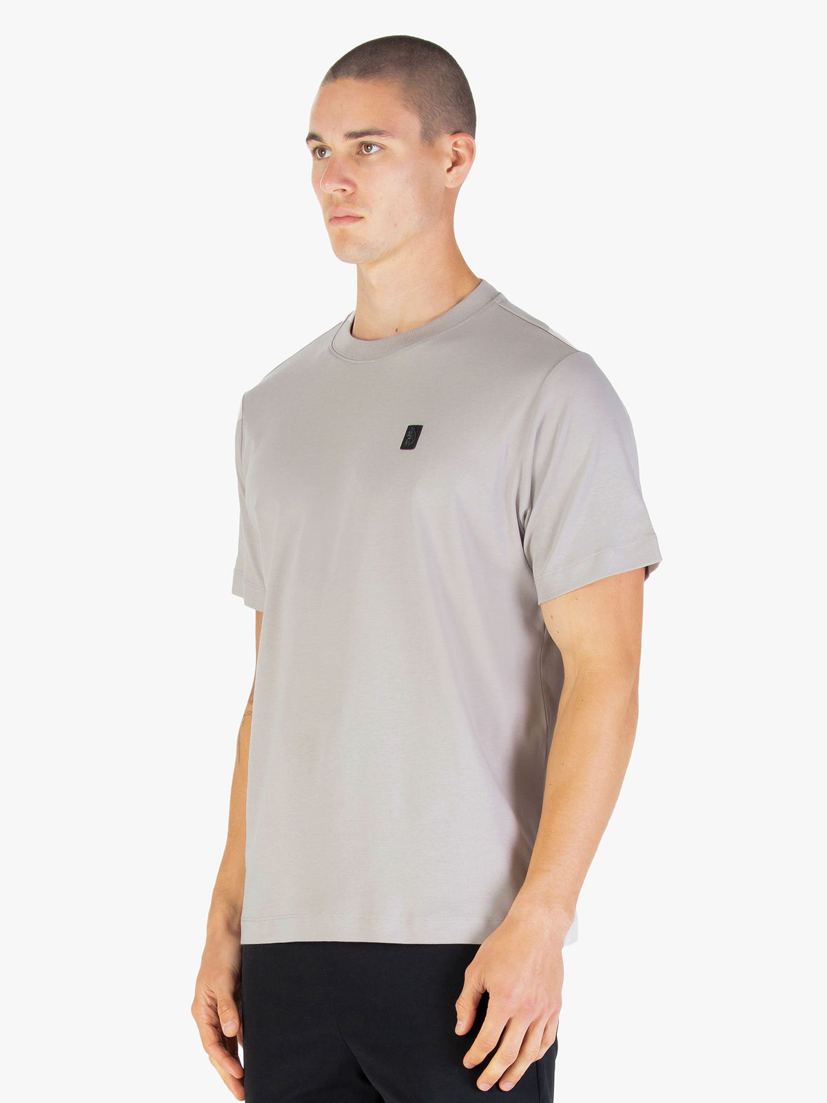 Men's relaxed-fit grey t-shirt with crew neck and short sleeves worn by a model - back view.