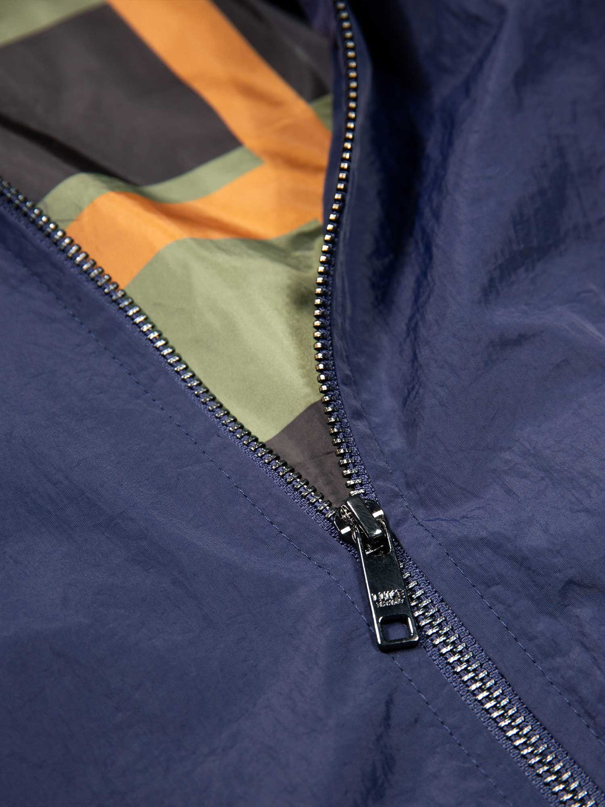Men's navy jacket with zip-up front and front pocket, detail view 2