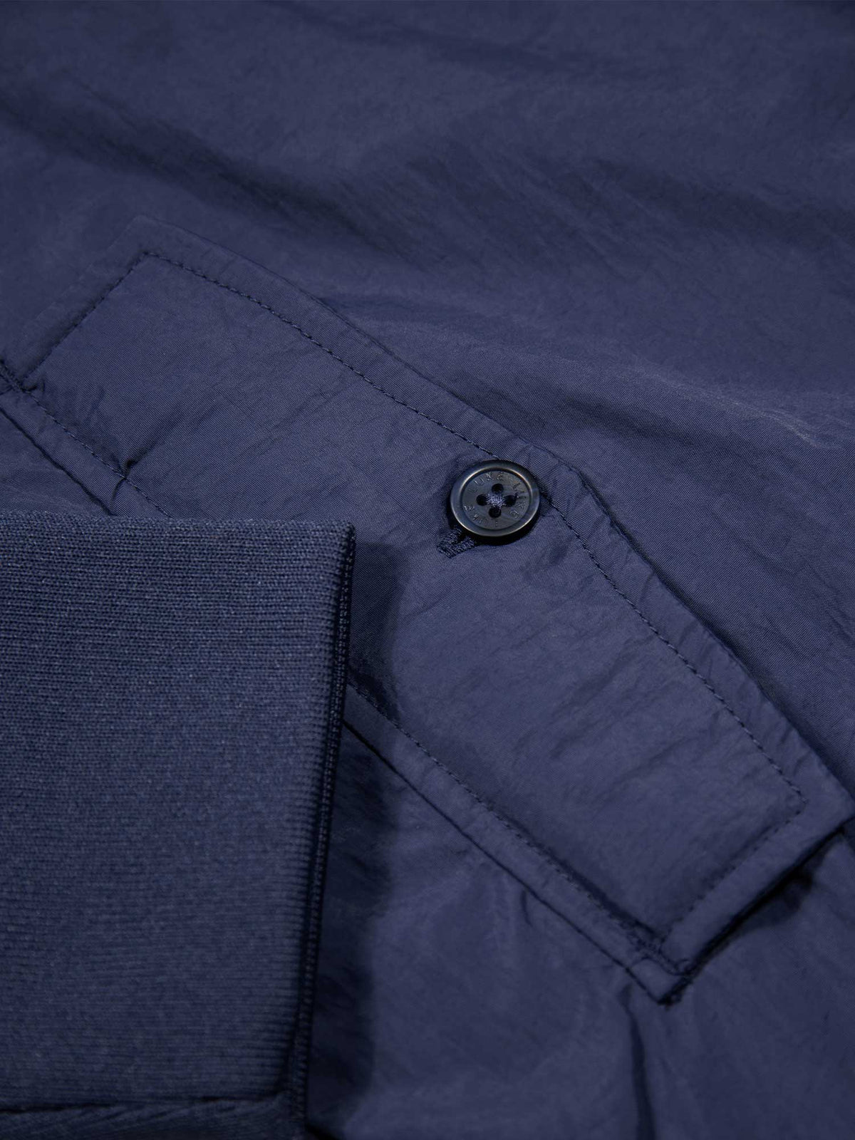 Men's navy jacket with zip-up front and front pocket, detail view 4