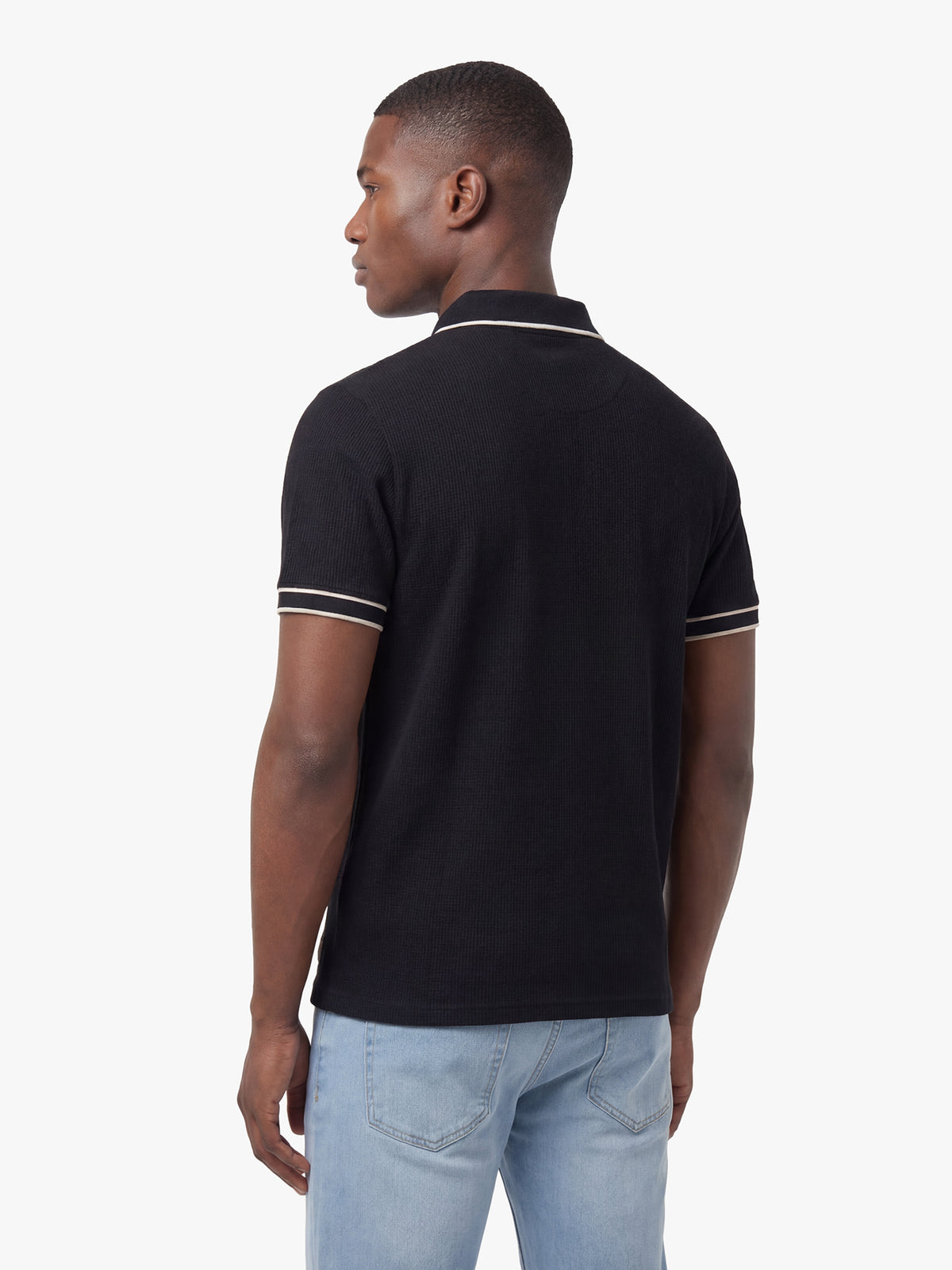 Men's black polo shirt with polo collar, back view
