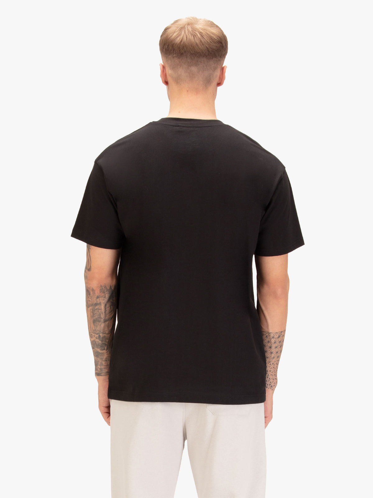 Men's relaxed-fit black t-shirt with crew neck and short sleeves, worn by a model, back view