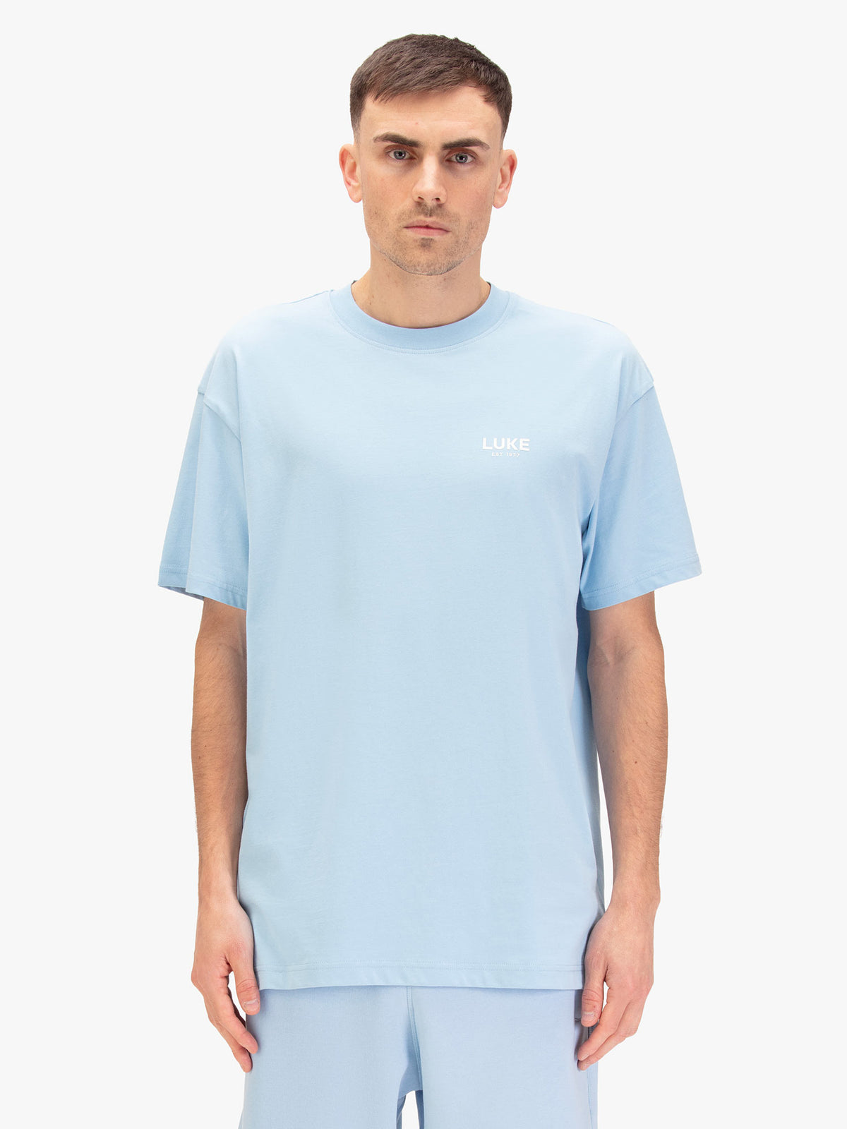Men's relaxed-fit blue t-shirt with crew neck and short sleeves, worn by a model, front view