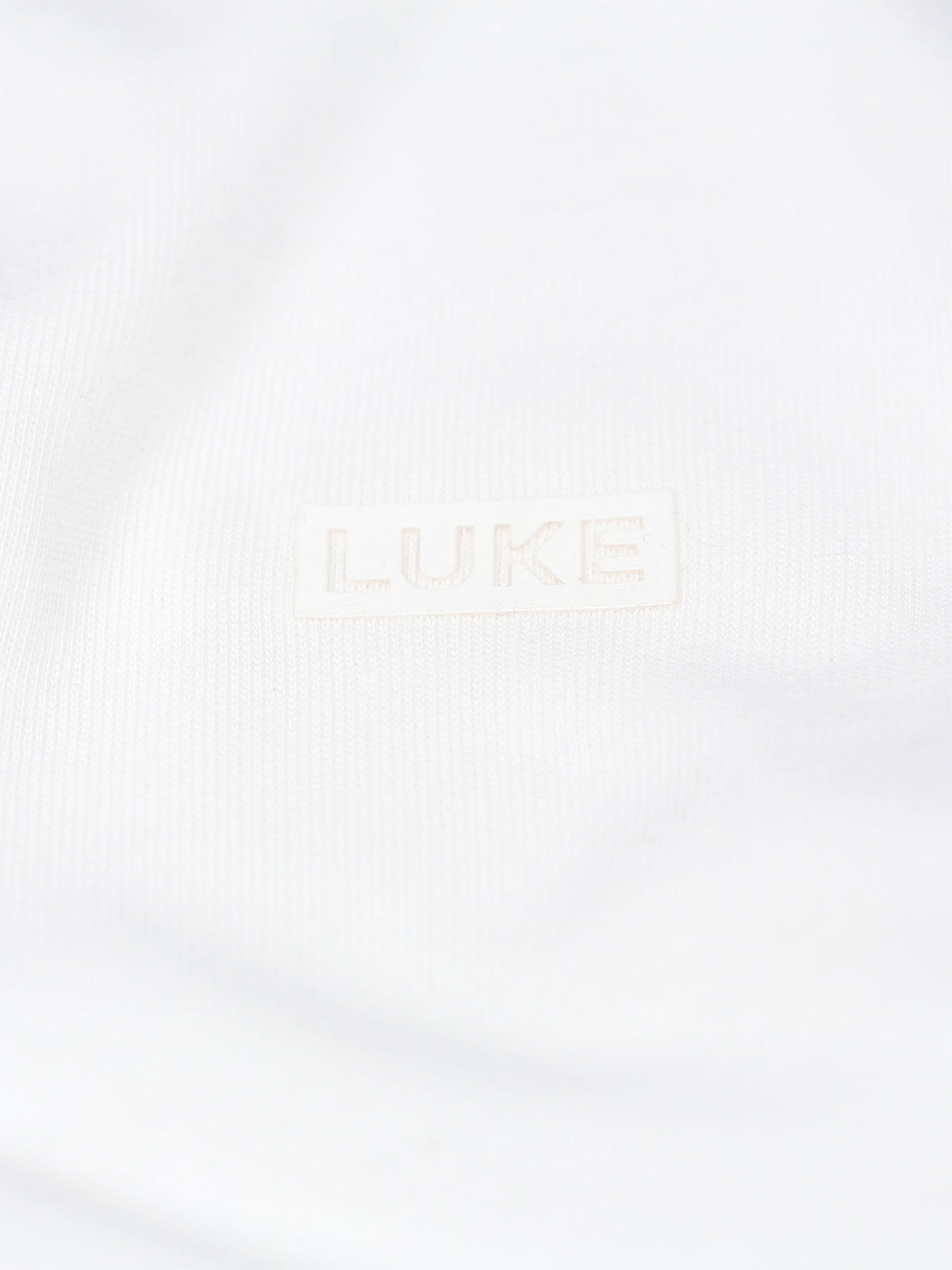 Men's white t-shirt with crew neck and short sleeves worn by a model - side view.