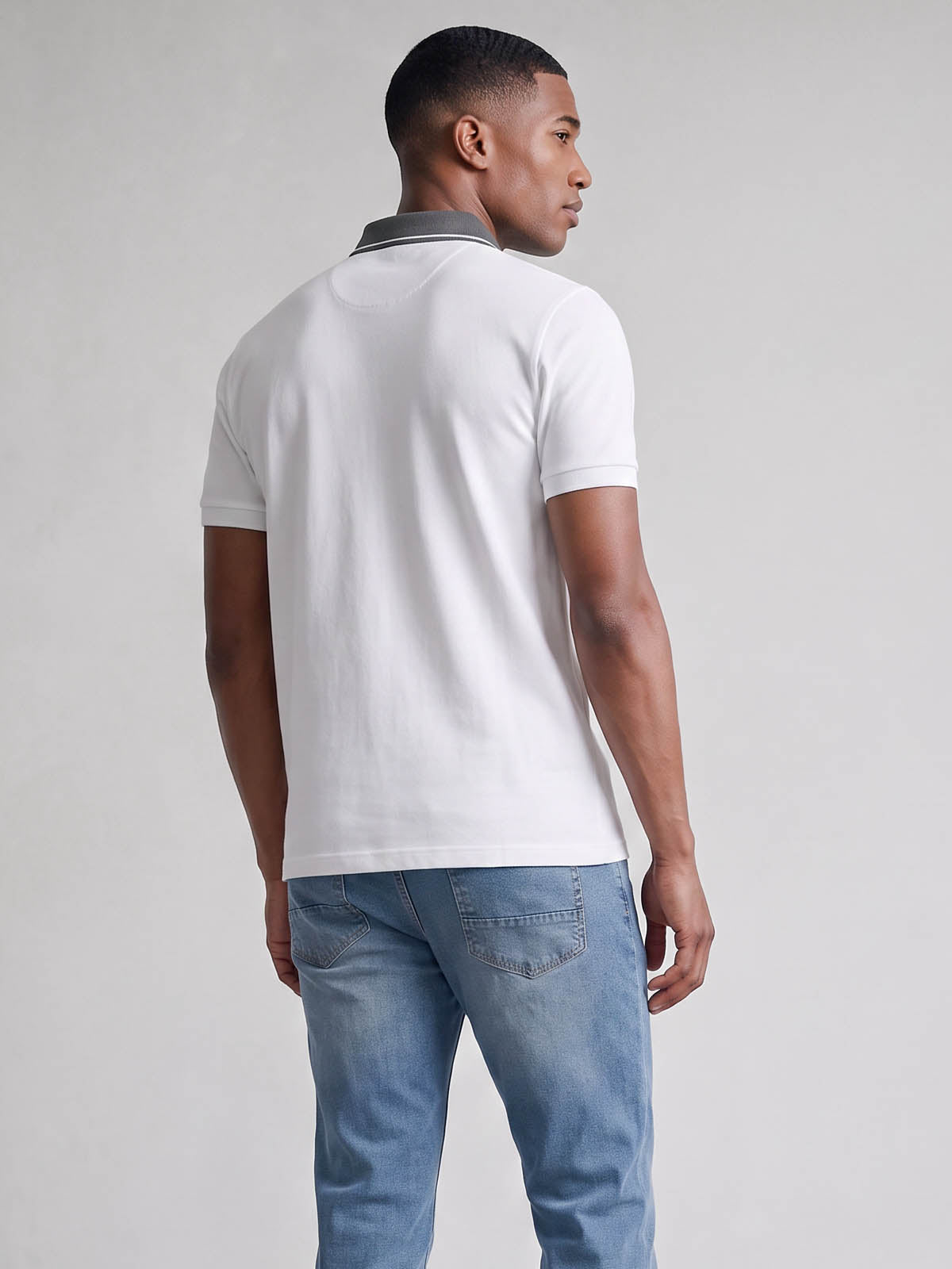 Back view of white LUKE 1977 Leo pique polo shirt worn by model
