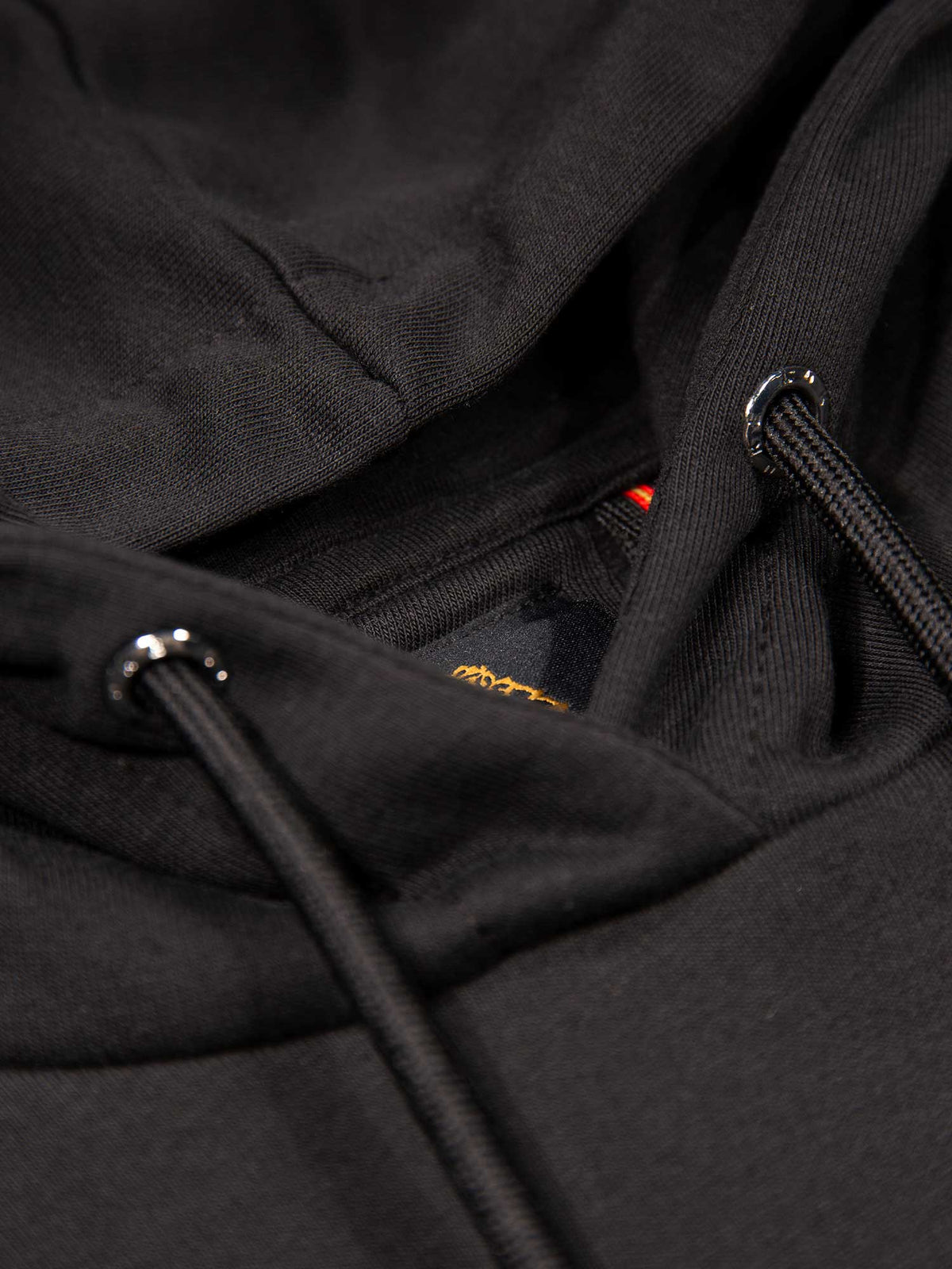 Men's black tracksuit with hoodie and matching joggers, detail view.