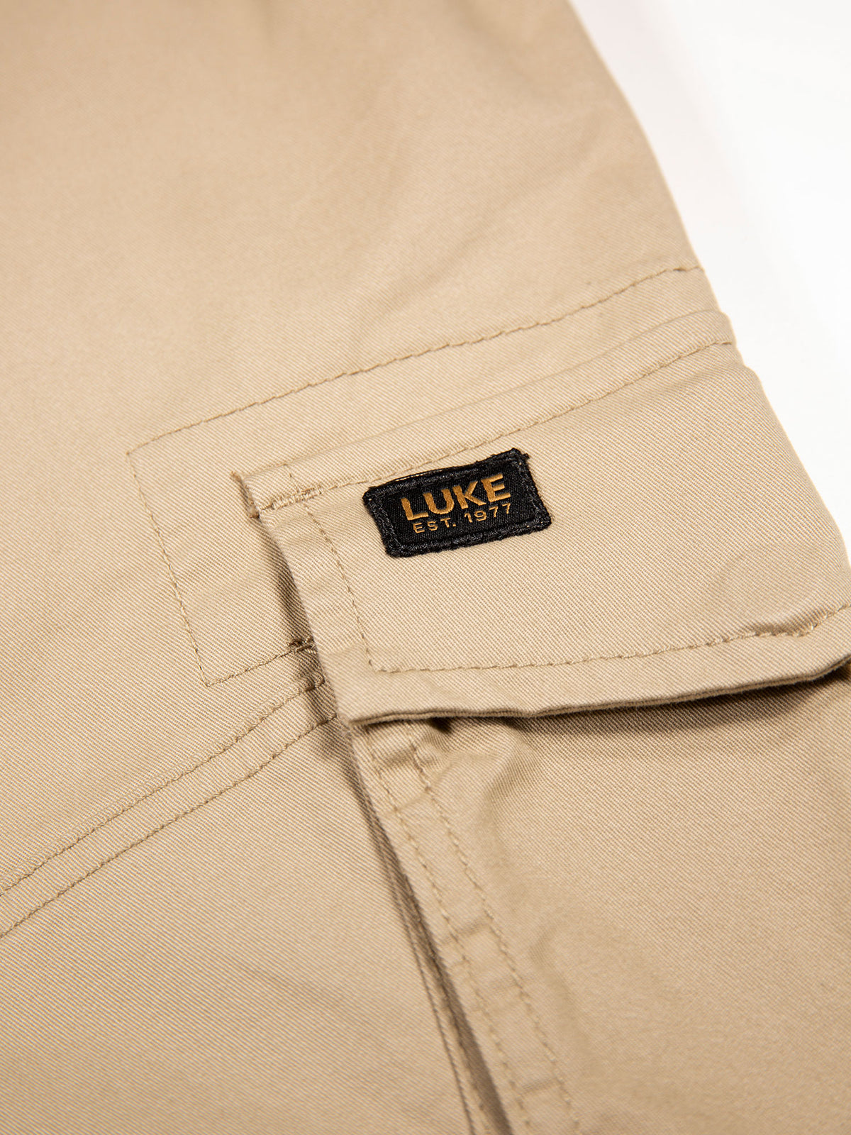 Men's beige cargo trousers with cargo pockets.