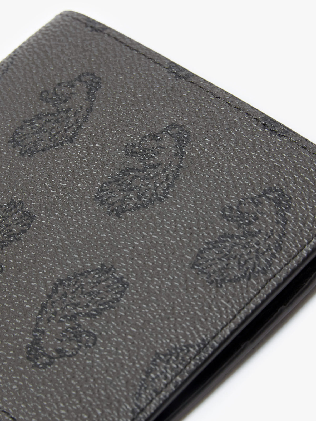 Close-up of lion head repeat print on black Noble bi-fold wallet
