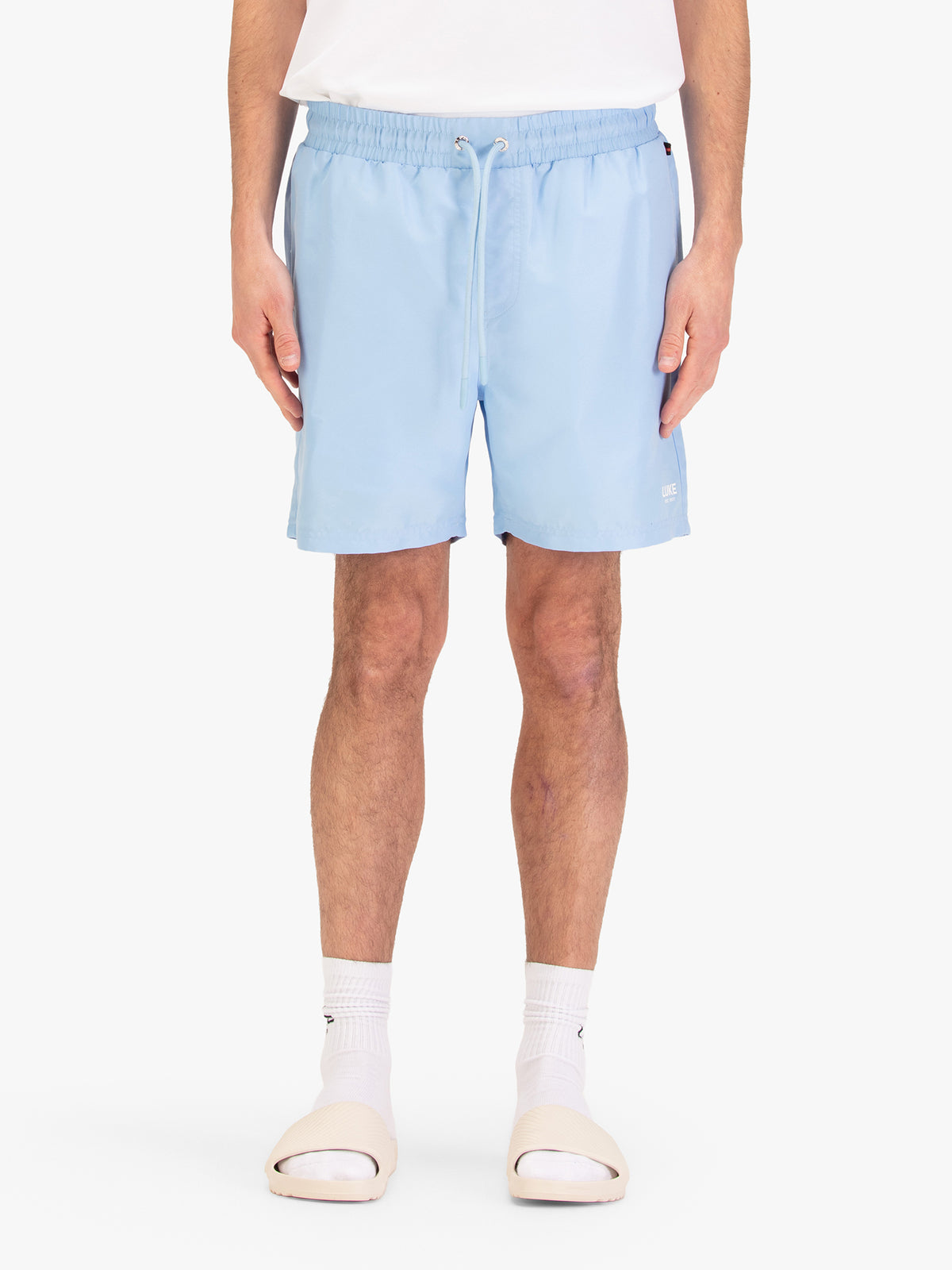 Men's blue-1 swim shorts with drawstring waistband, worn by a model, front view