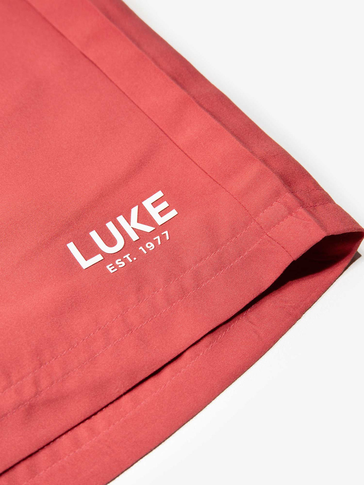 Men's red swim shorts with drawstring waistband, detail view 2