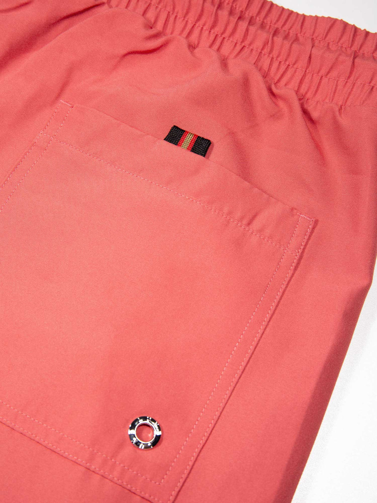 Men's red swim shorts with drawstring waistband, detail view 3