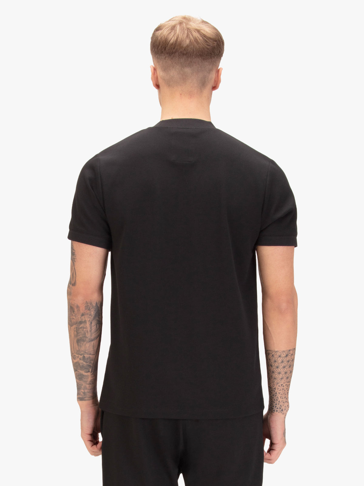 Men's black t-shirt with crew neck and short sleeves, worn by a model, back view