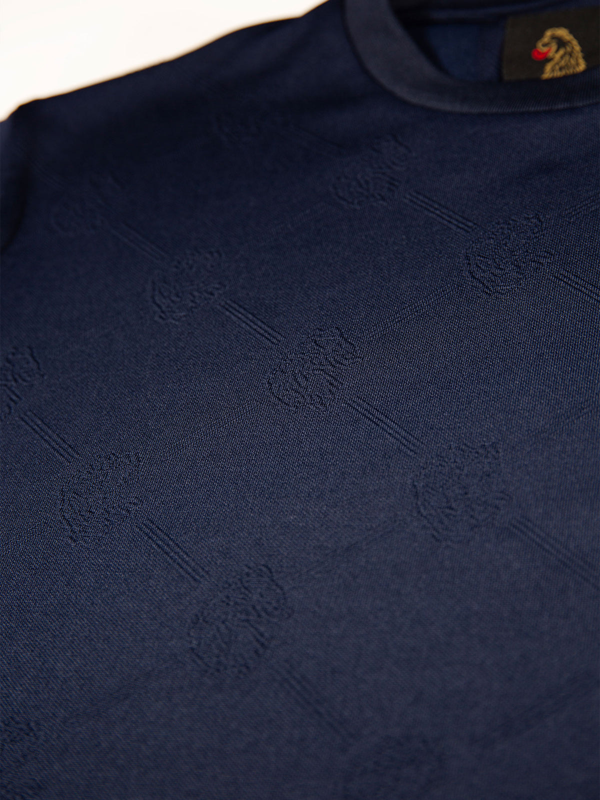 Men's navy t-shirt with crew neck and short sleeves worn by a model - side view.