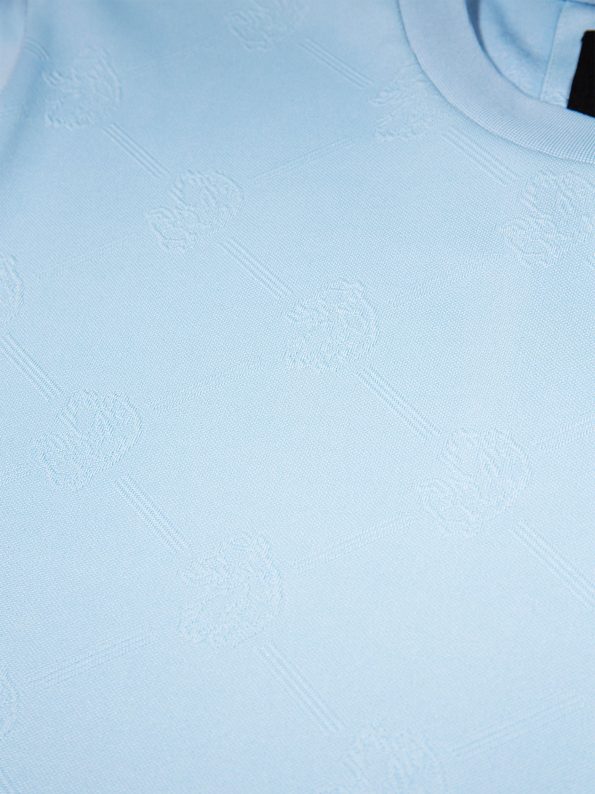 Men's blue t-shirt with crew neck and short sleeves worn by a model - side view.