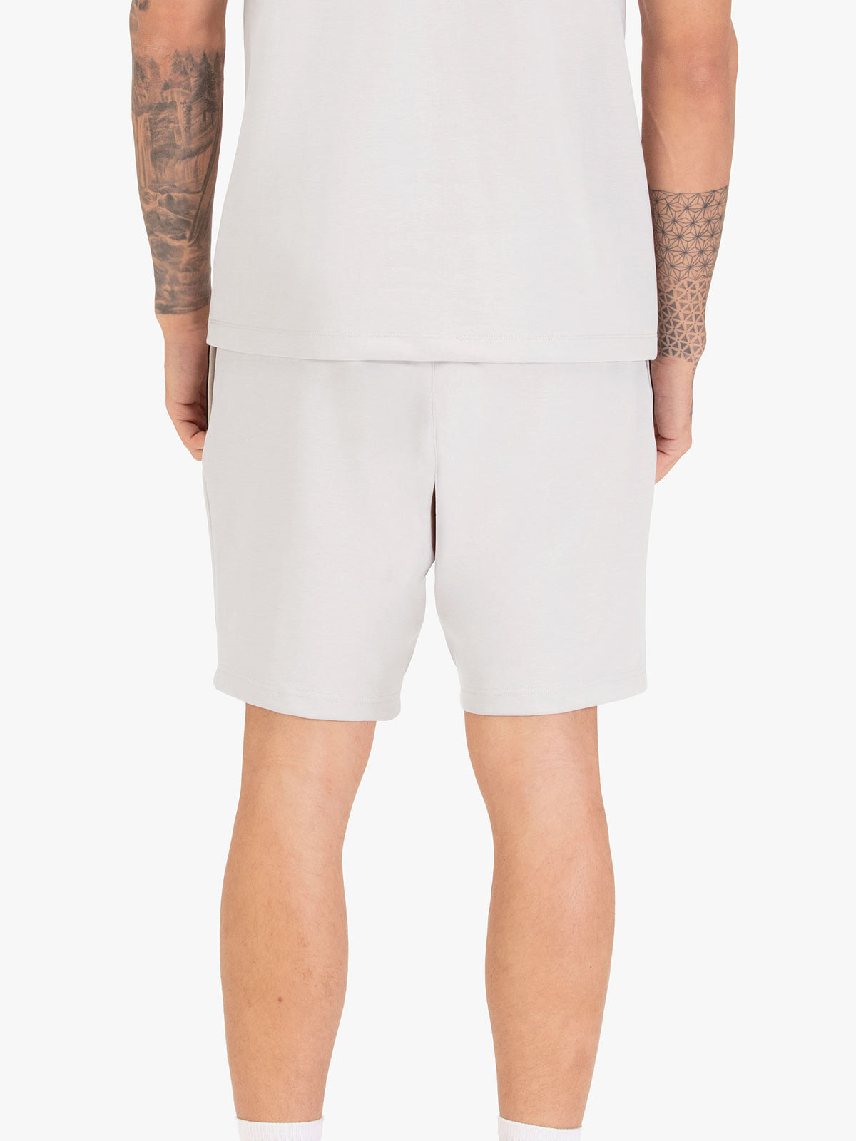 Men's grey shorts with drawstring waistband, worn by a model, back view