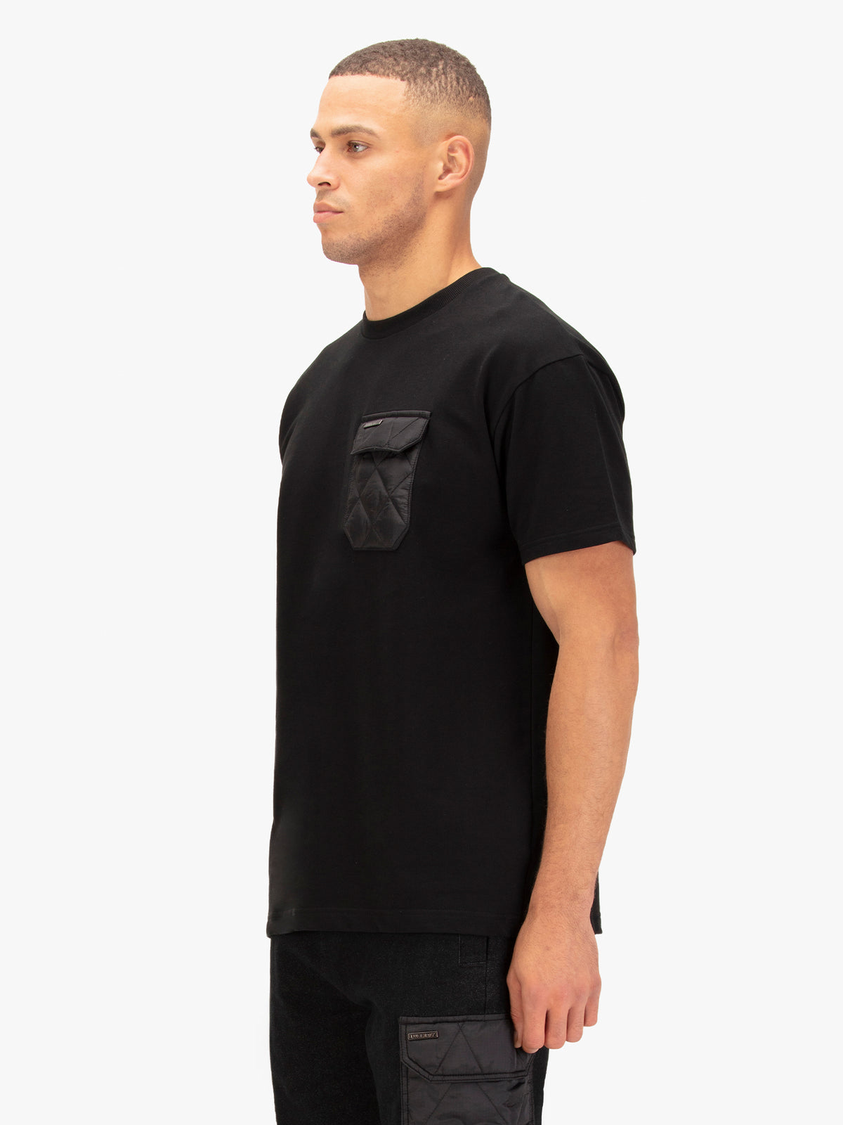 Men's black t-shirt with crew neck and short sleeves worn by a model - back view.