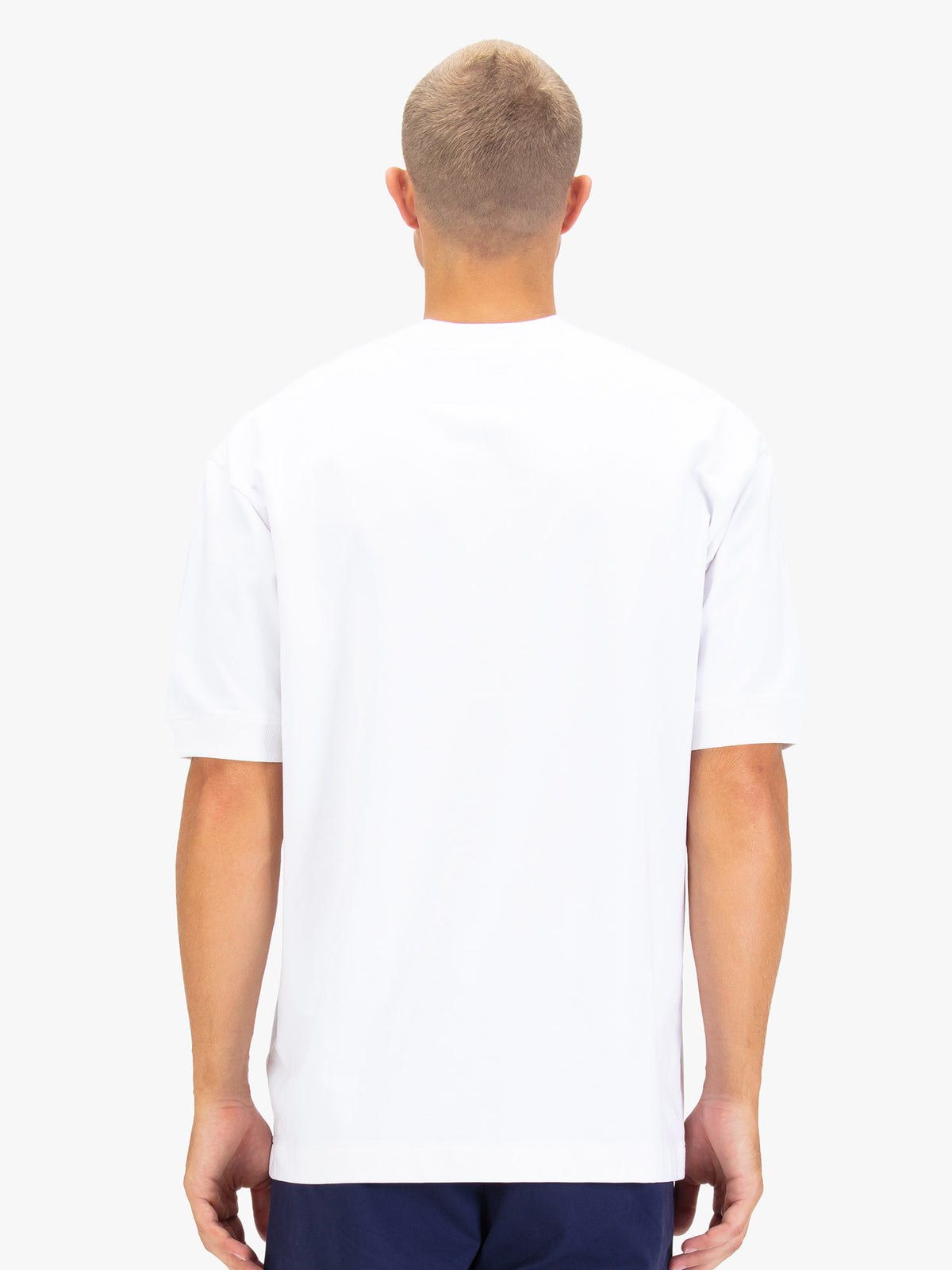 Men's white t-shirt with crew neck and short sleeves worn by a model - back view.