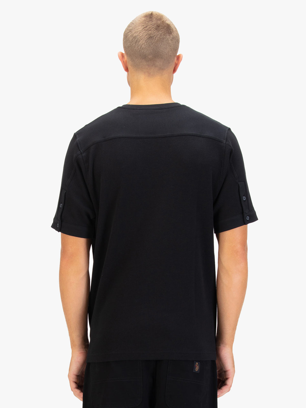 Men's black t-shirt with crew neck and short sleeves worn by a model - back view.