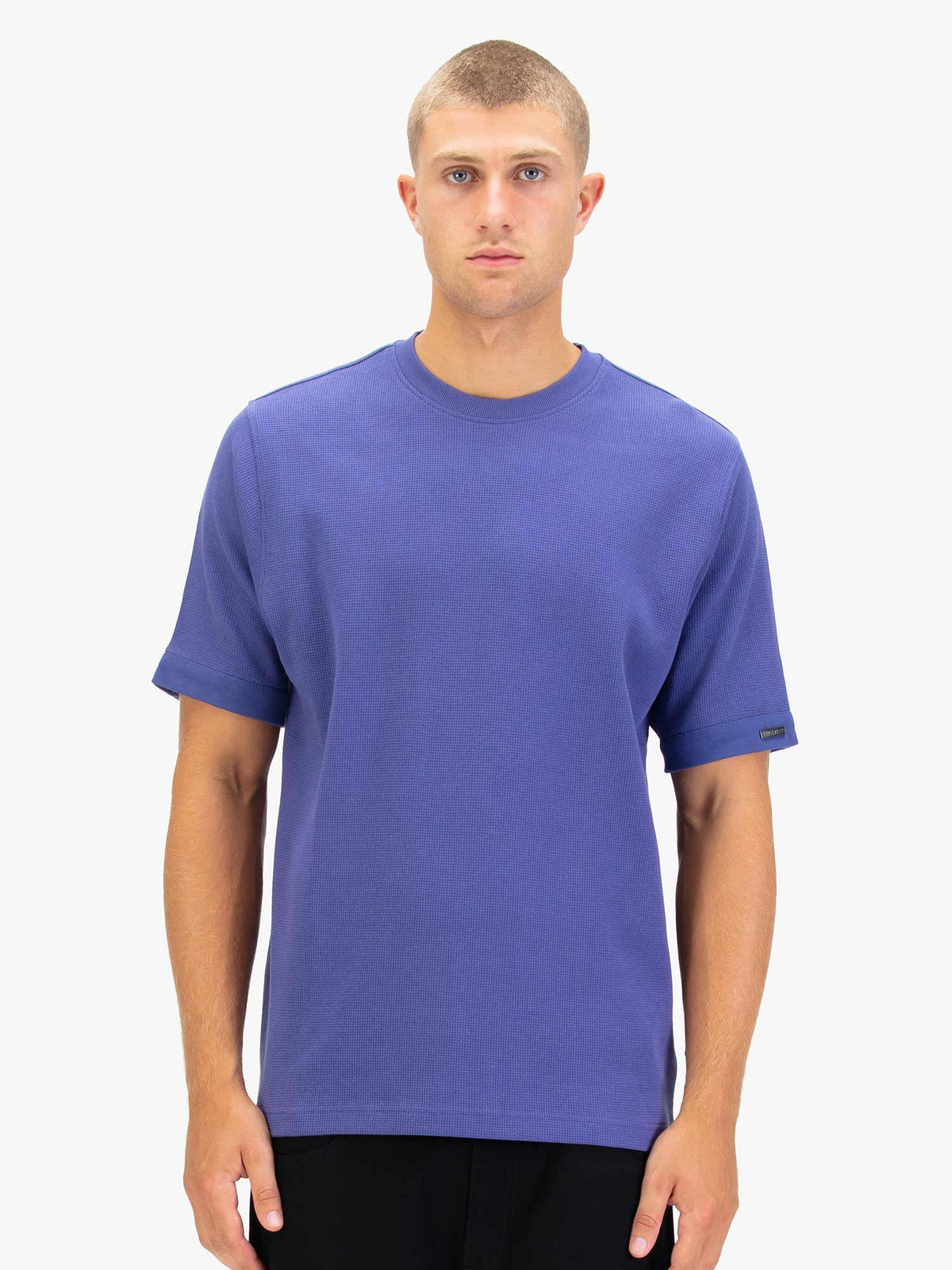 Men's purple t-shirt with crew neck and short sleeves worn by a model - front view.