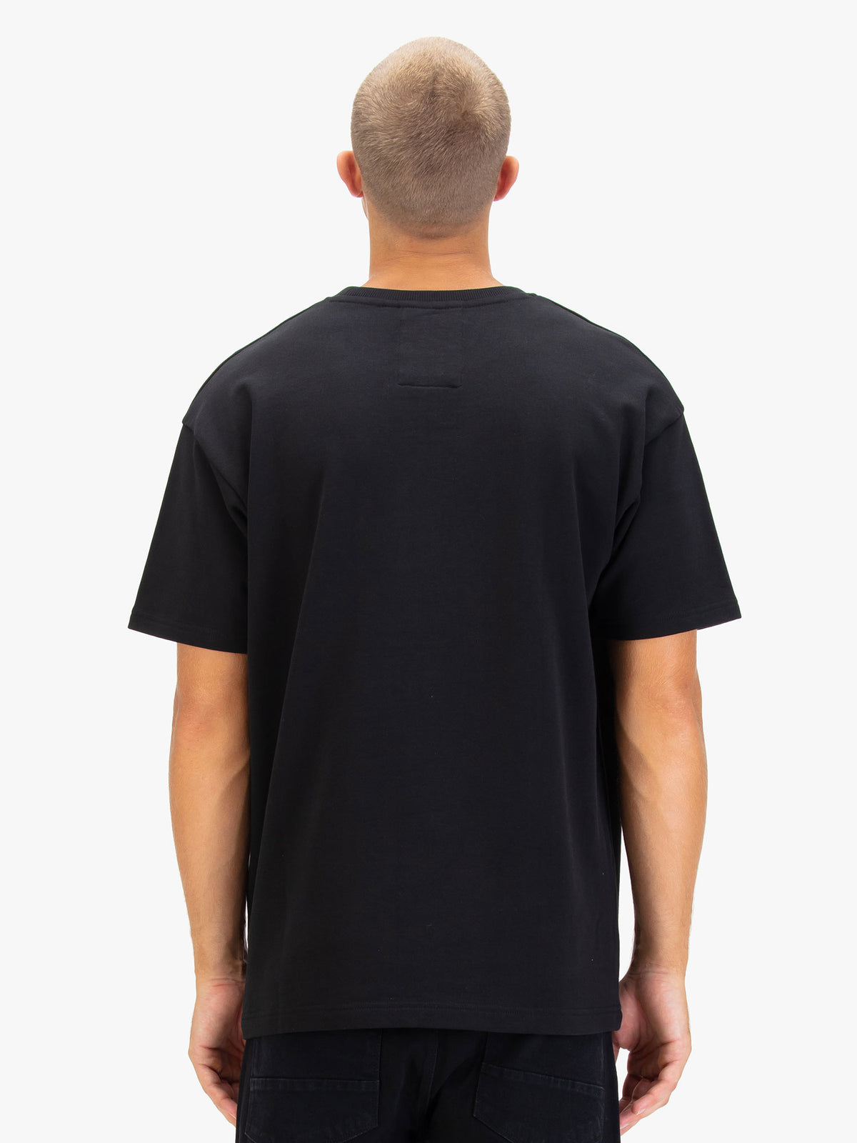 Men's black t-shirt with crew neck and short sleeves worn by a model - back view.