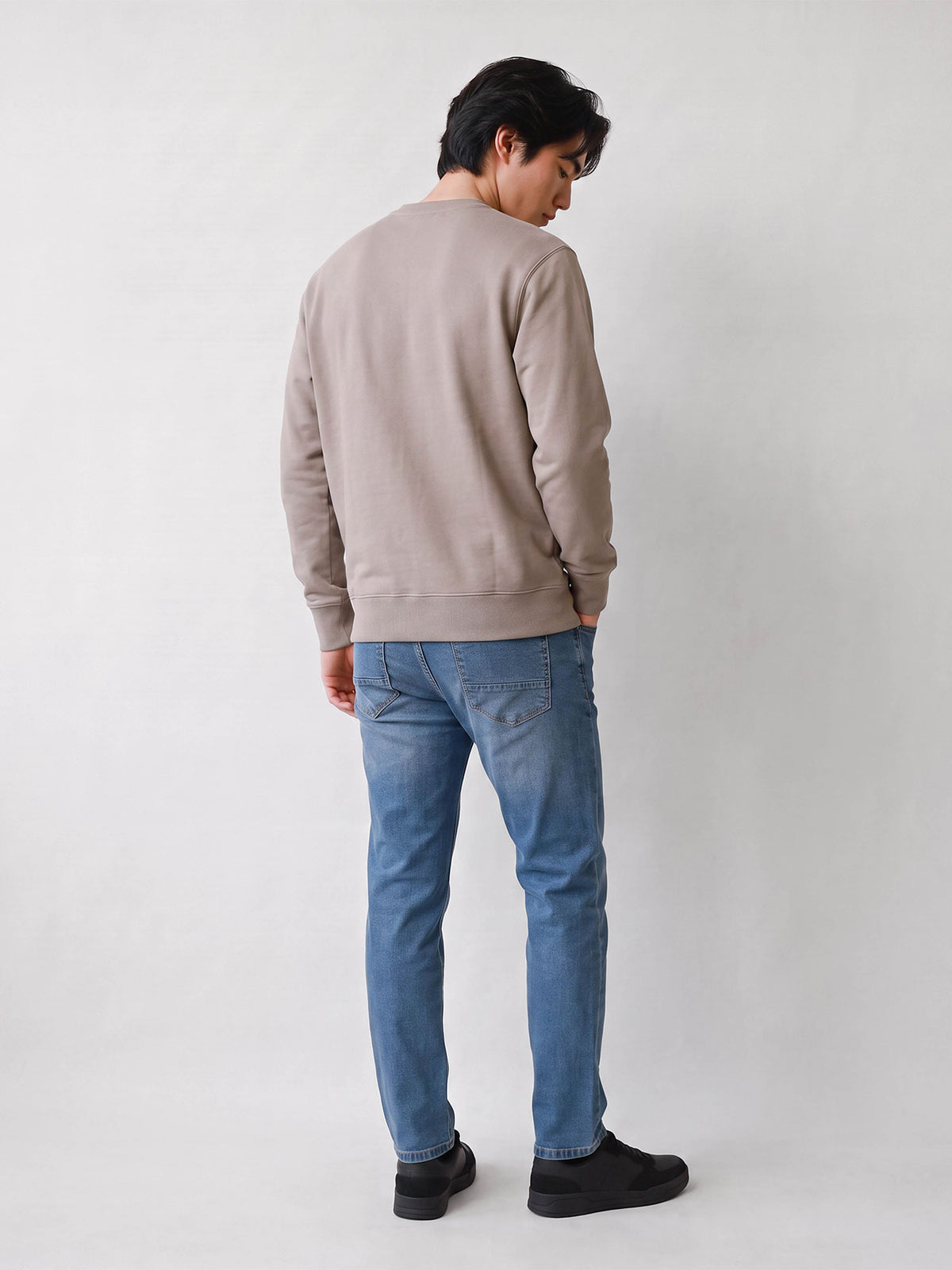 Full length back view of stone LUKE 1977 Parker crew neck sweatshirt worn by model