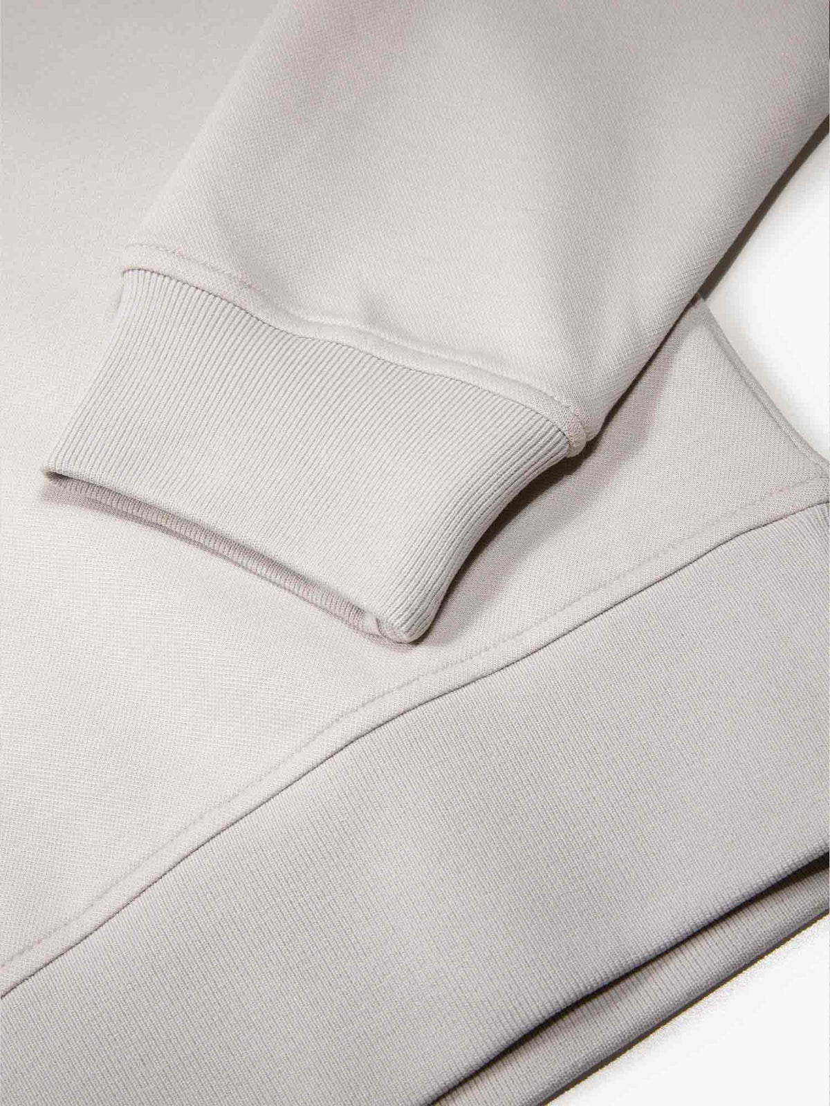 Men's grey tracksuit with sweatshirt and matching joggers, detail image of the cuffs.