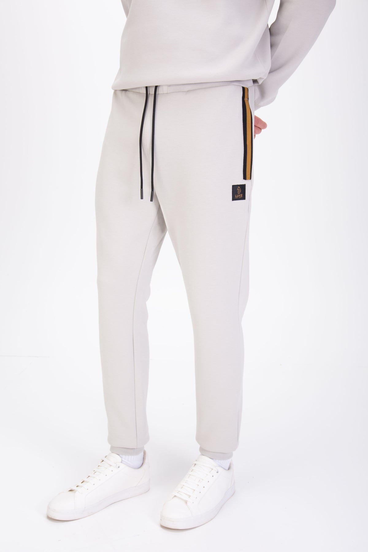 Men's grey tracksuit with sweatshirt and matching joggers. Joggers front view.
