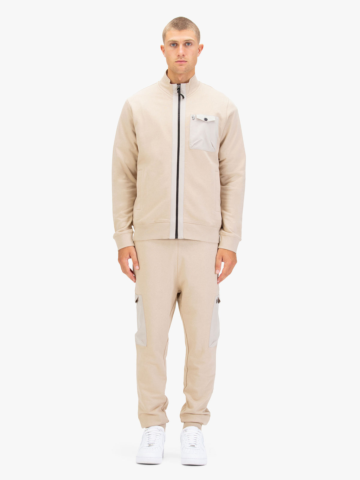 Men's beige tracksuit with zip-through sweatshirt and matching joggers.