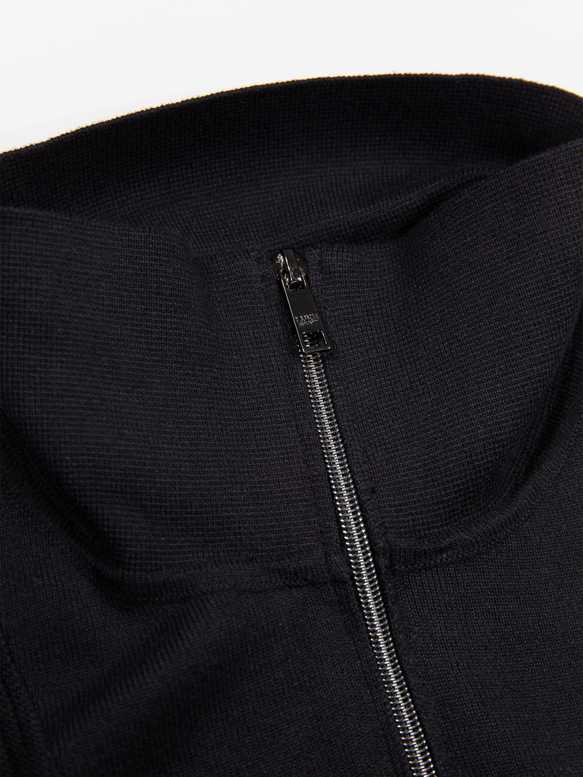 Close-up of quarter zip on black Lifton knitted funnel neck