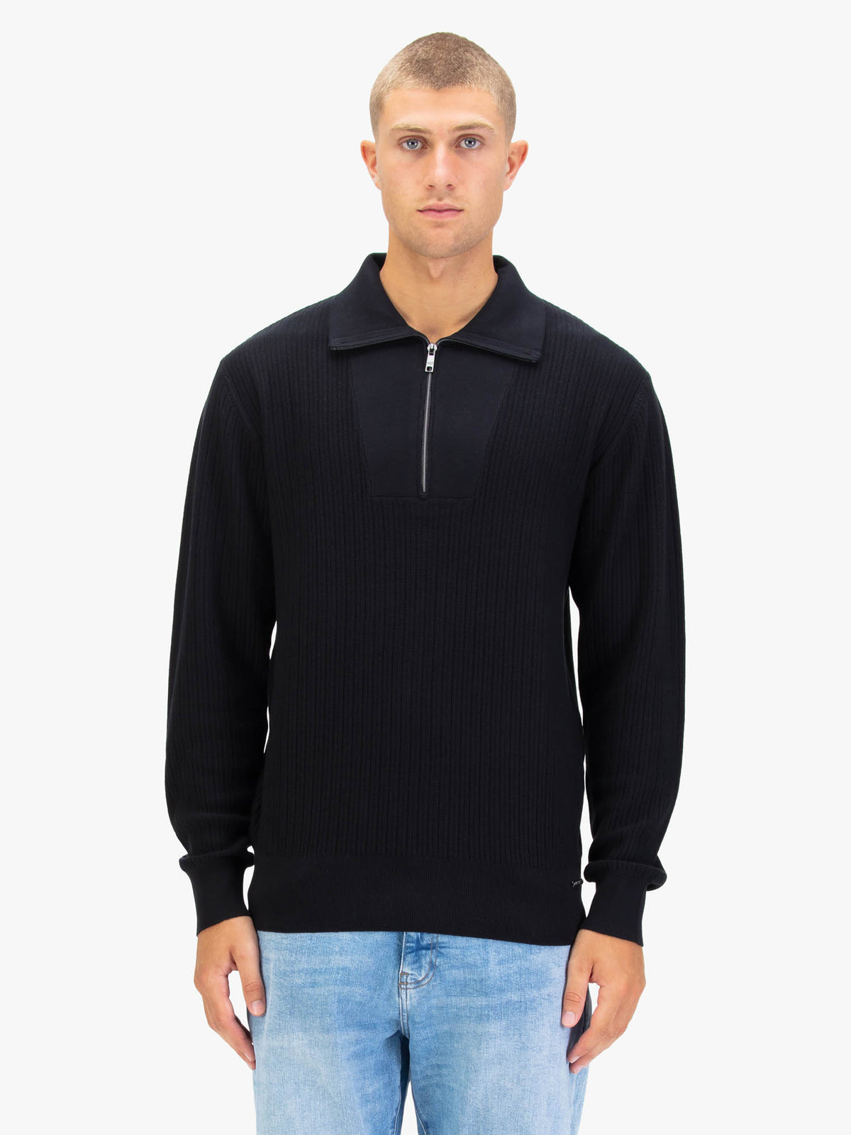 Man wearing black LUKE 1977 Lifton quarter zip knit with the zip open