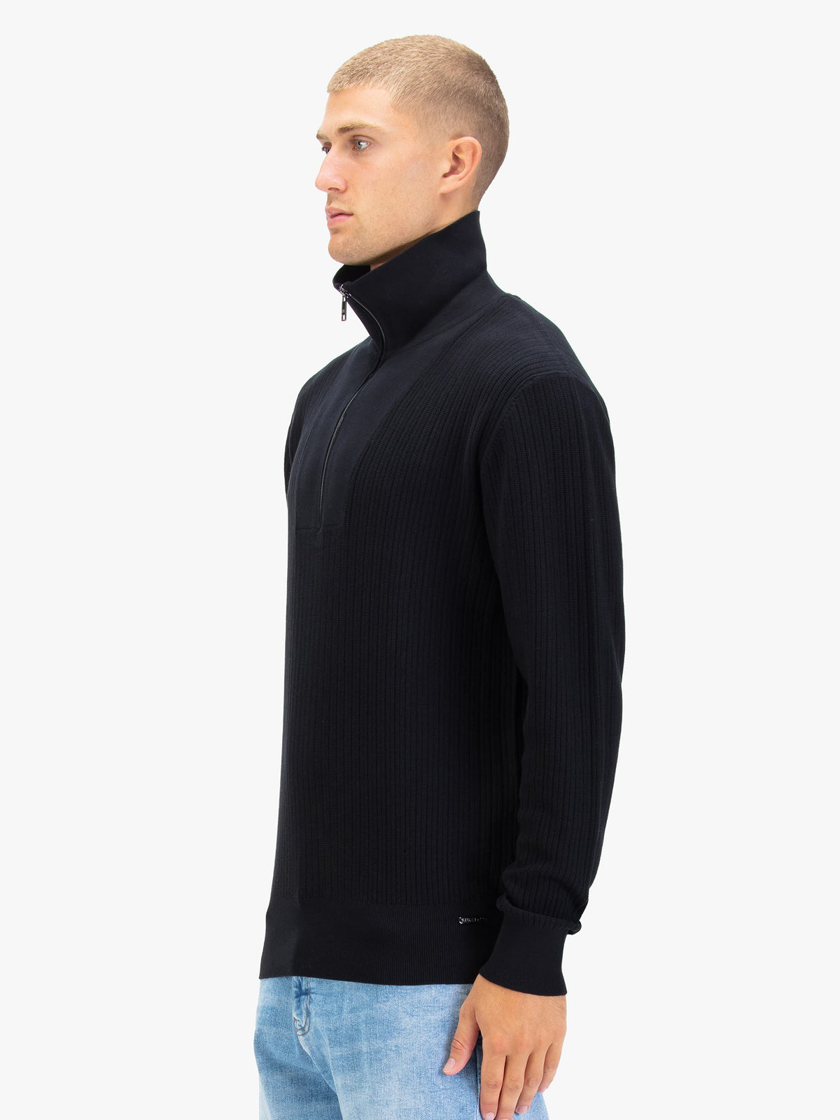 Side view of man wearing black LUKE 1977 Lifton quarter zip knitted funnel