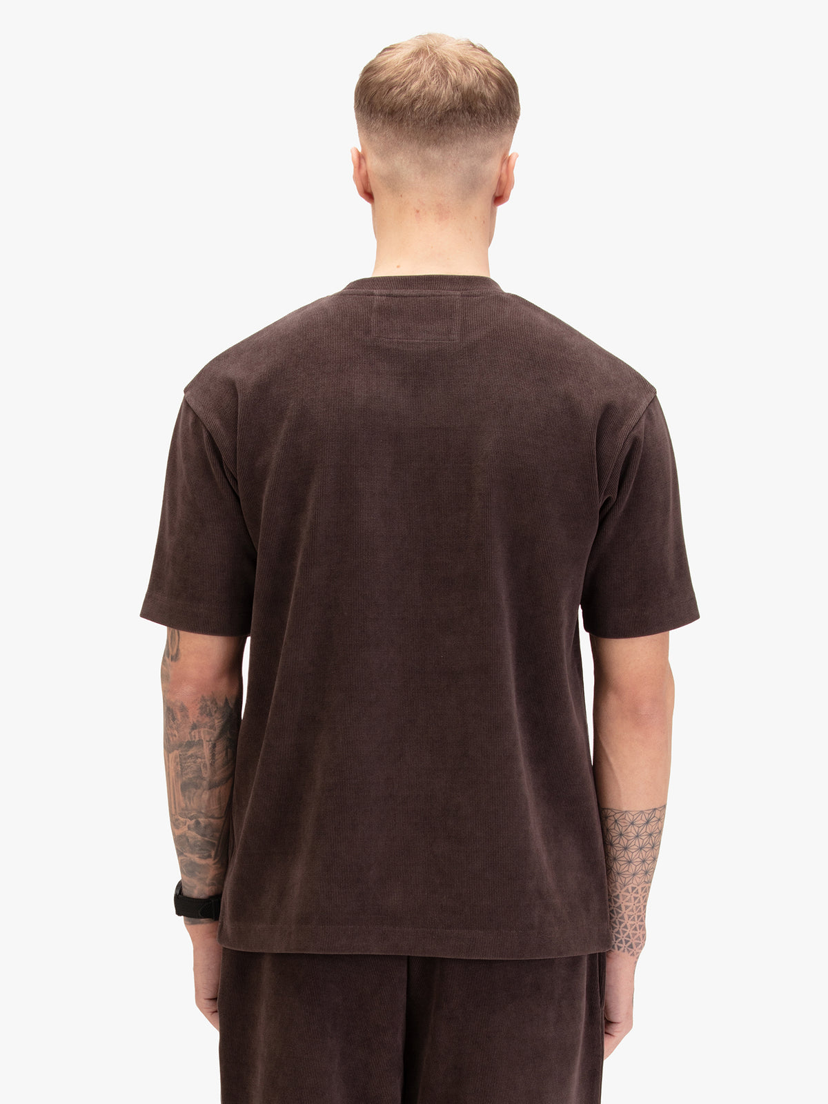 Men's relaxed-fit brown t-shirt with crew neck and short sleeves, worn by a model, back view