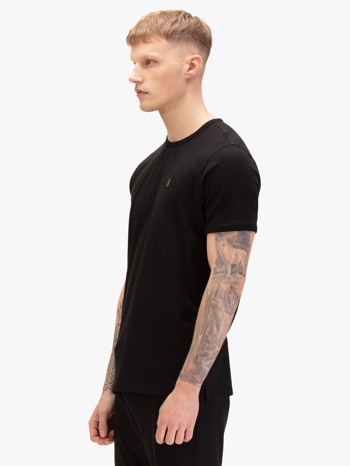 Men's black t-shirt with crew neck and short sleeves, worn by a model, side view