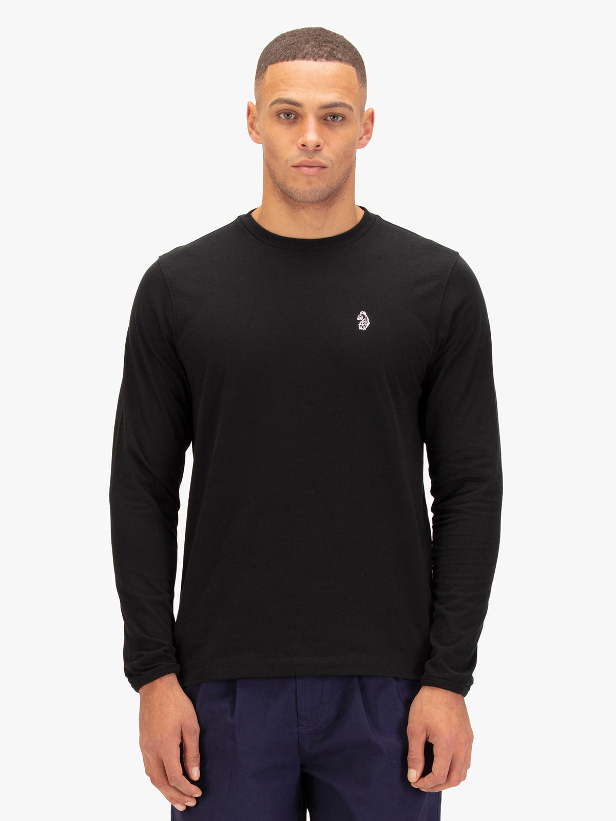 Men's black long sleeved t-shirt with crew neck worn by a model - front view.