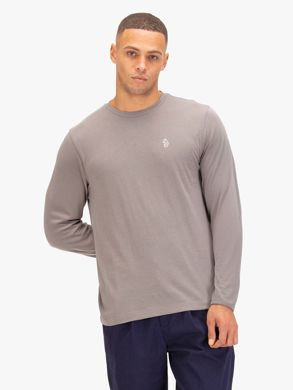 Men's grey long sleeved t-shirt with crew neck worn by a model - front view.
