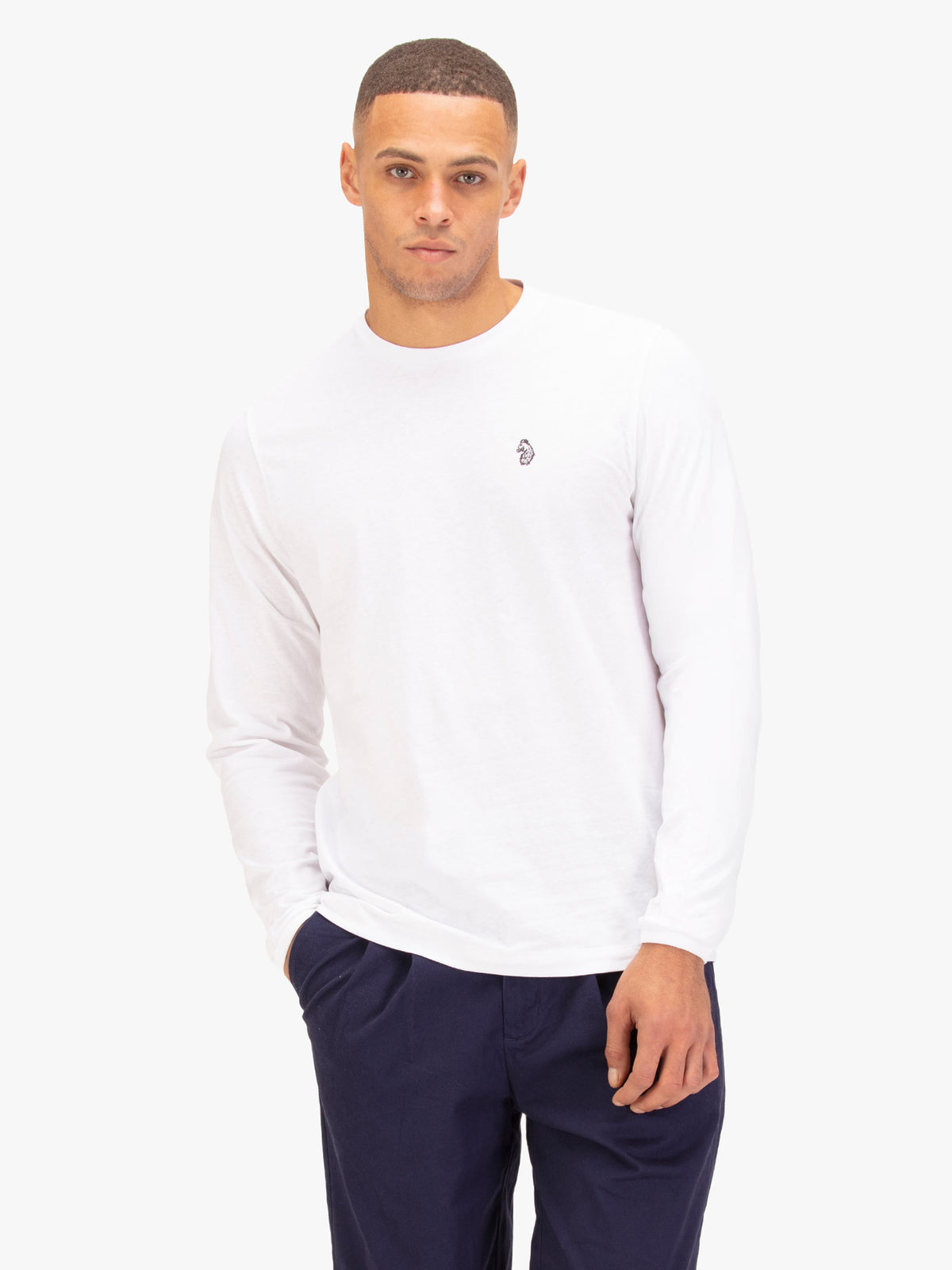 Men's white long sleeved t-shirt with crew neck worn by a model - front view.