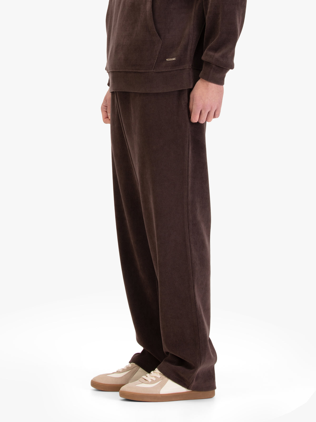 Men's straight-leg brown joggers, worn by a model, side view