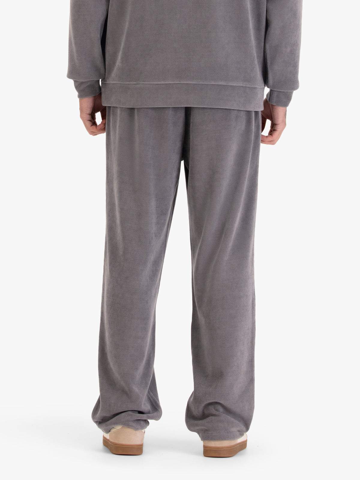 Men's straight-leg grey joggers, worn by a model, back view