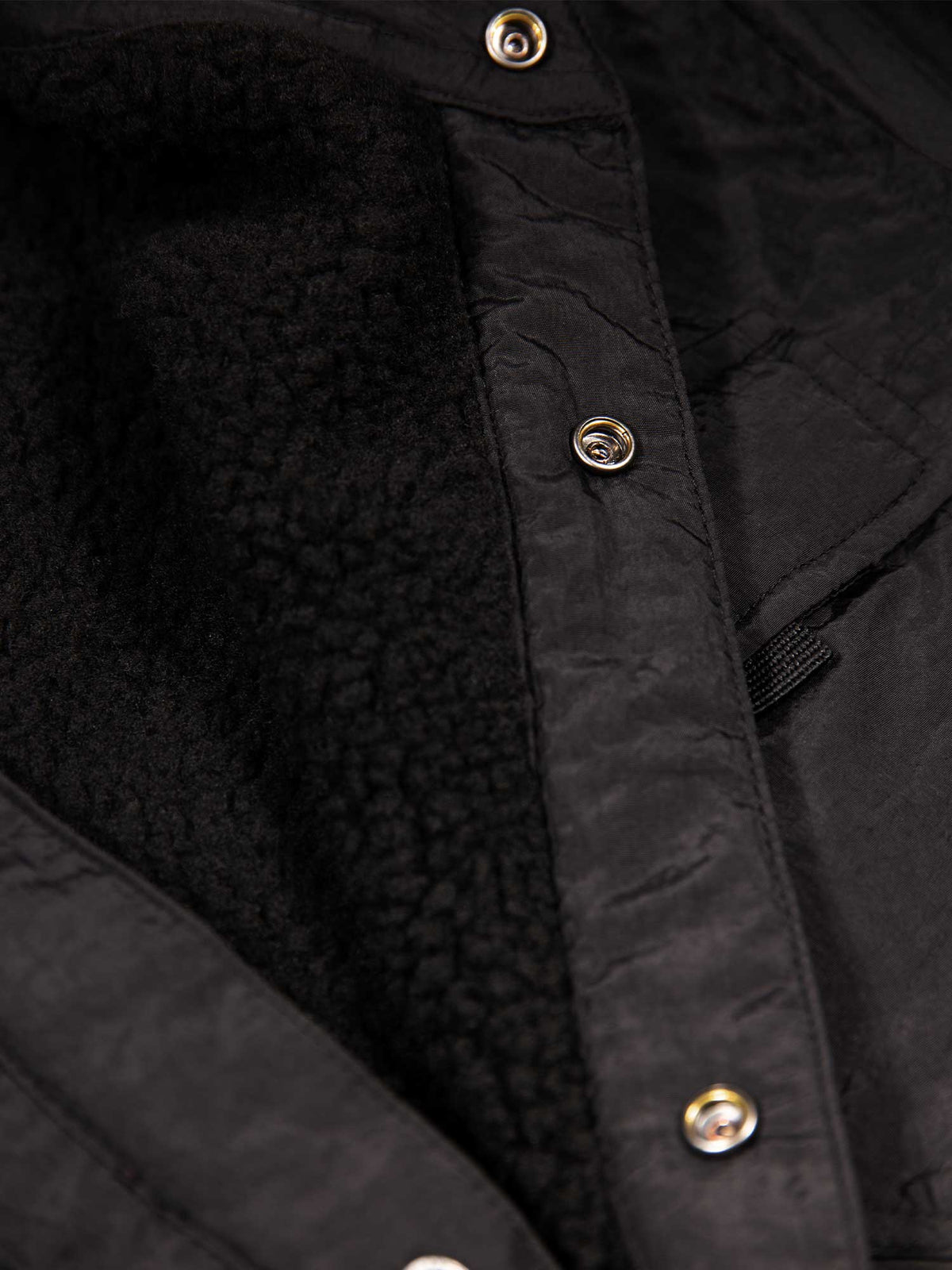 Men's black jacket with button-up front and front pocket, detail view 3