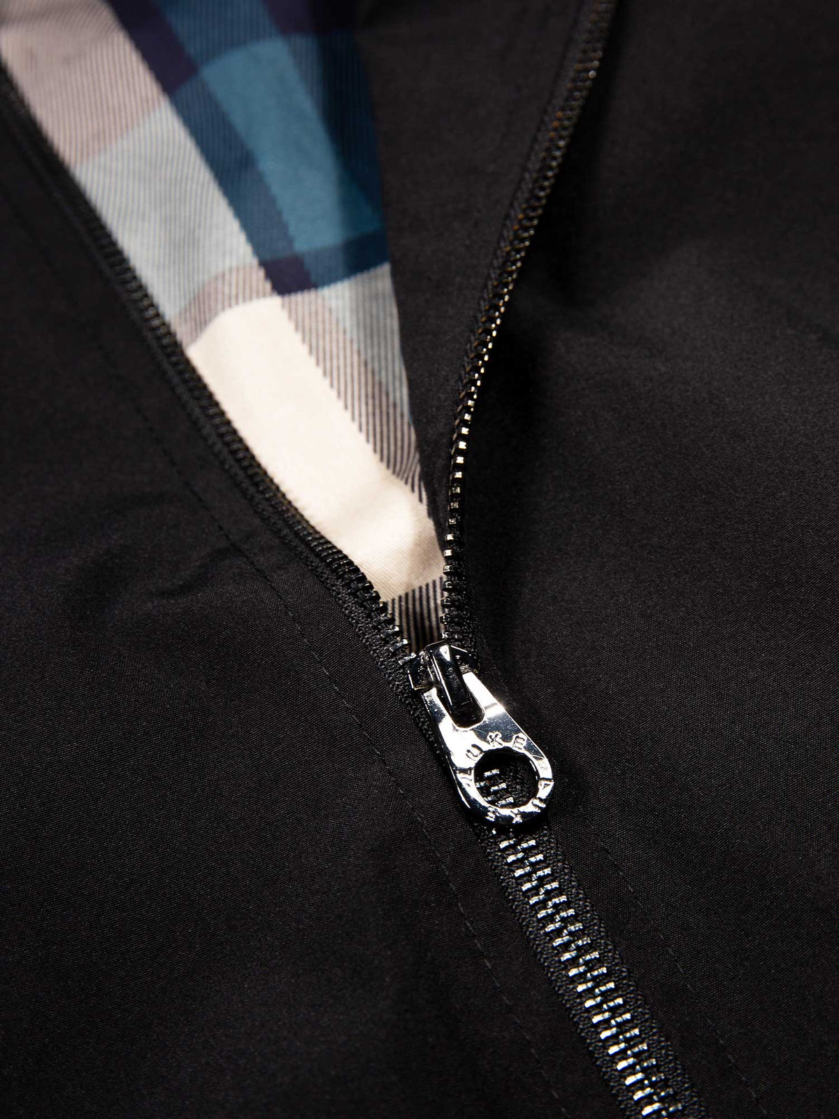 Men's black jacket with zip-up front and front pocket, detail view 5