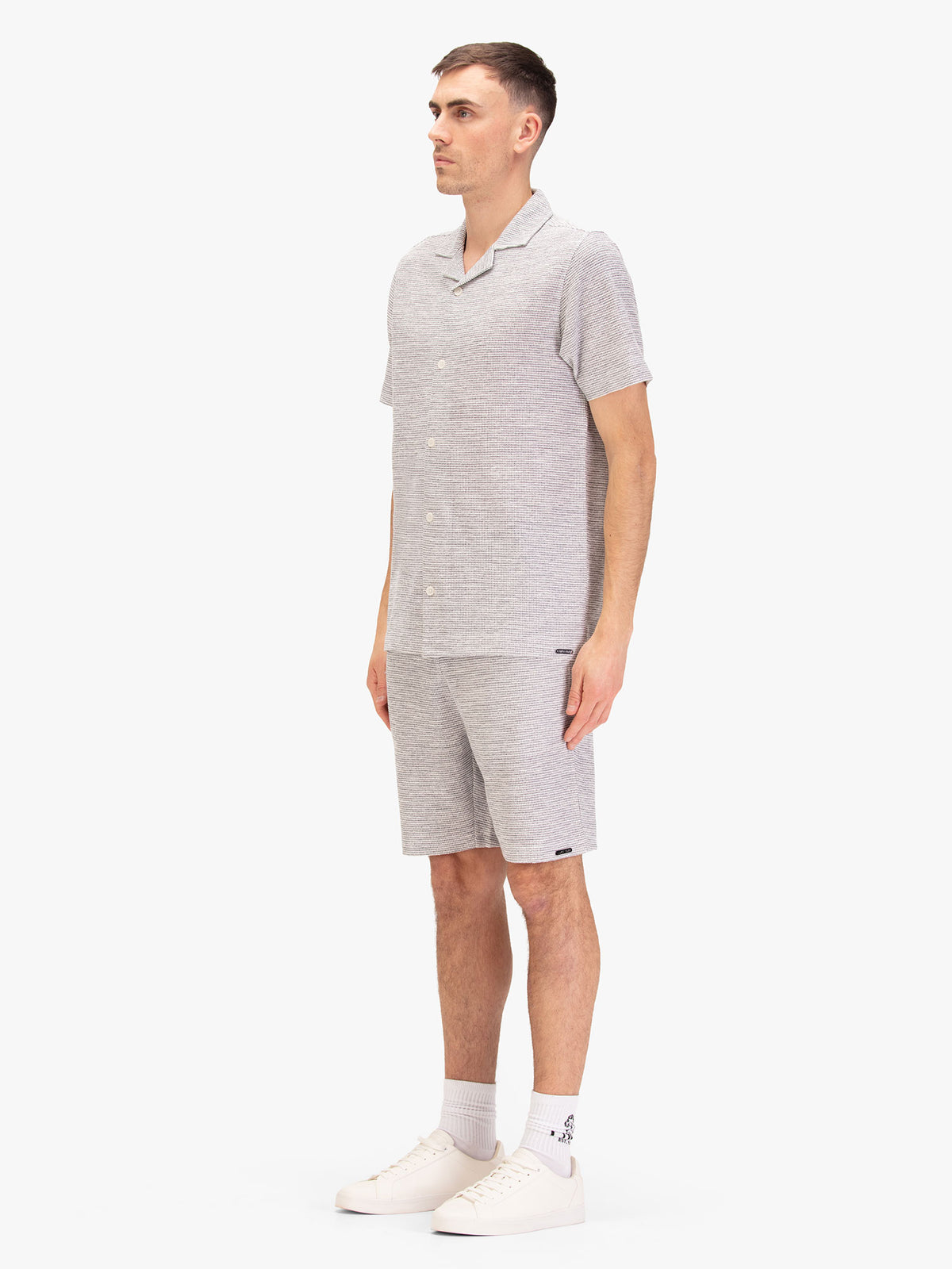Men's grey short set with short-sleeve shirt and matching shorts, worn by a model.