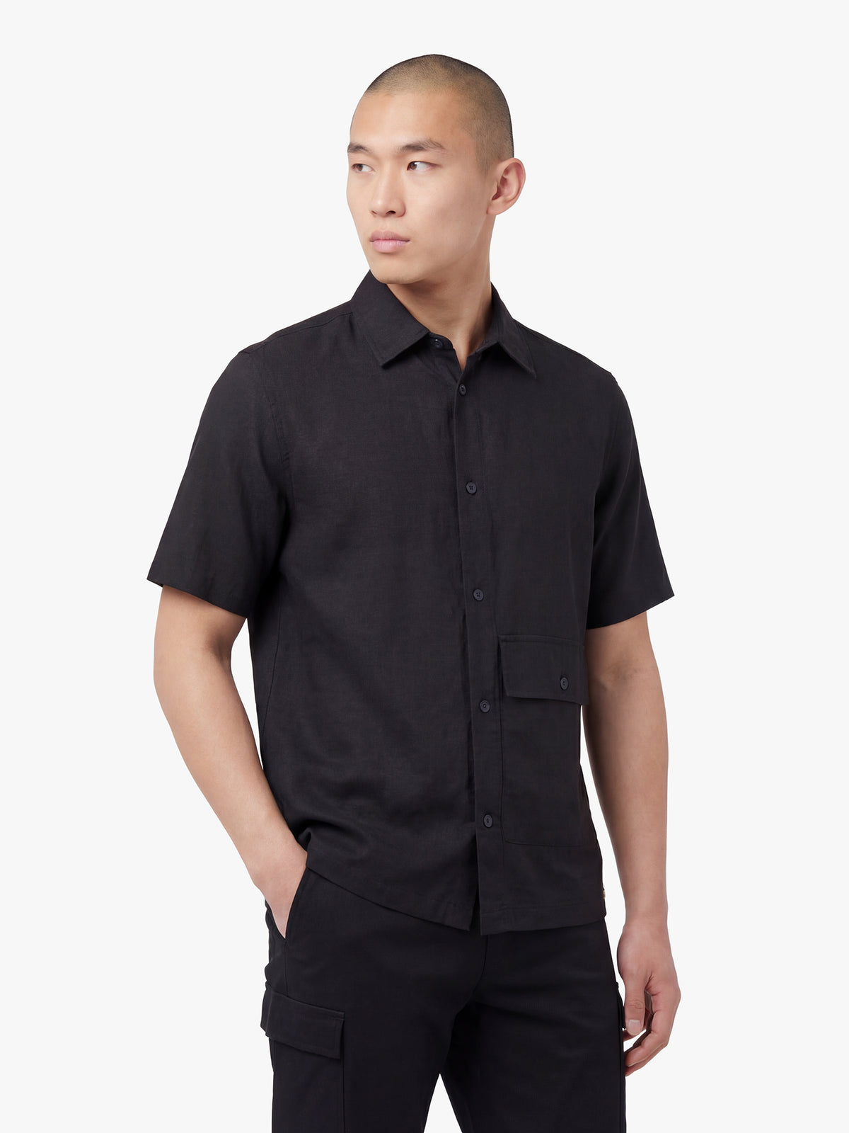 Men's relaxed-fit black shirt with button-up front, back view