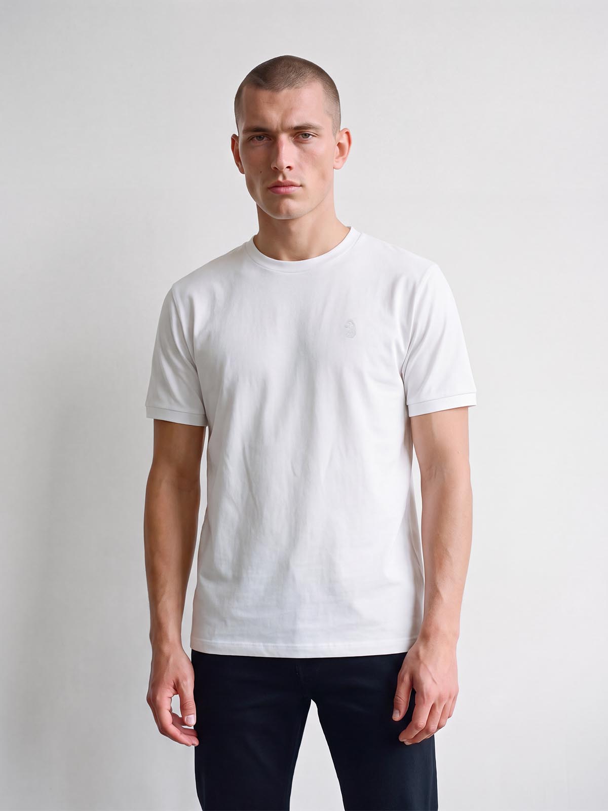 Man wearing white LUKE 1977 Leo pique t-shirt, front view